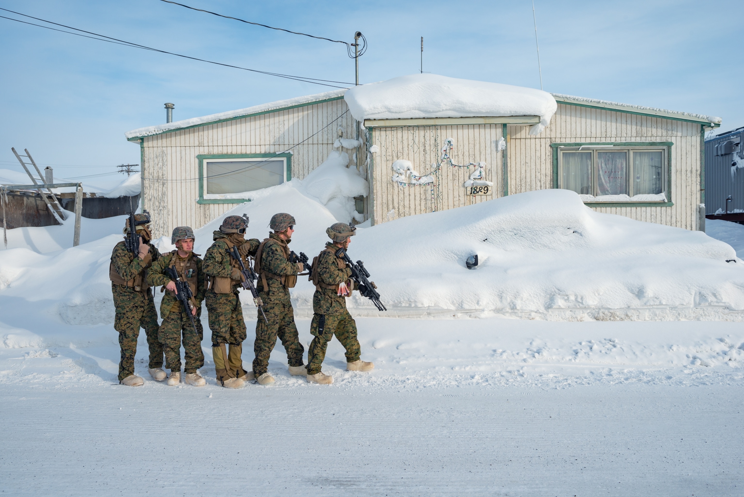 armed soldiers walking in line.