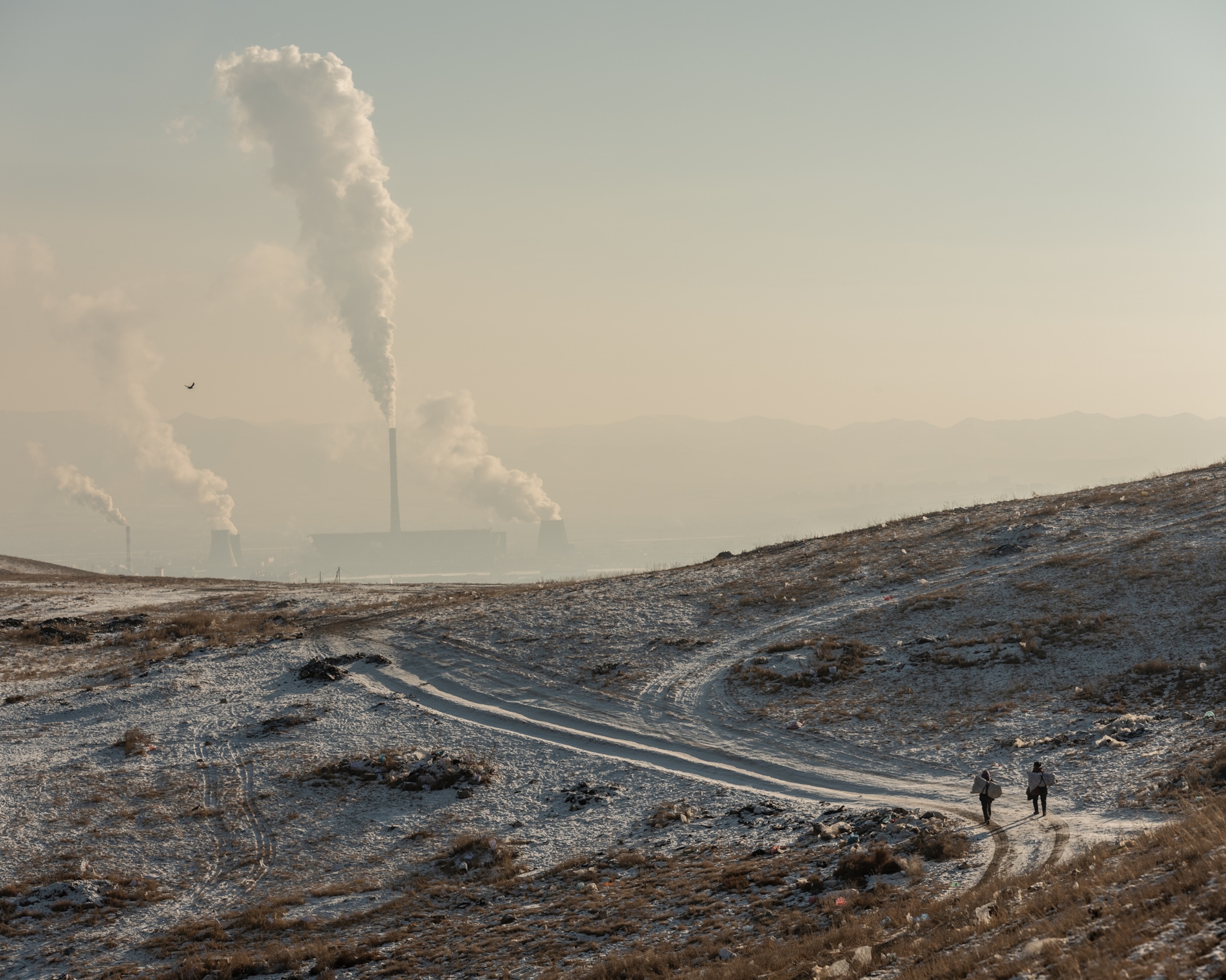 Picture of two men walking winter country road with smokes on background.