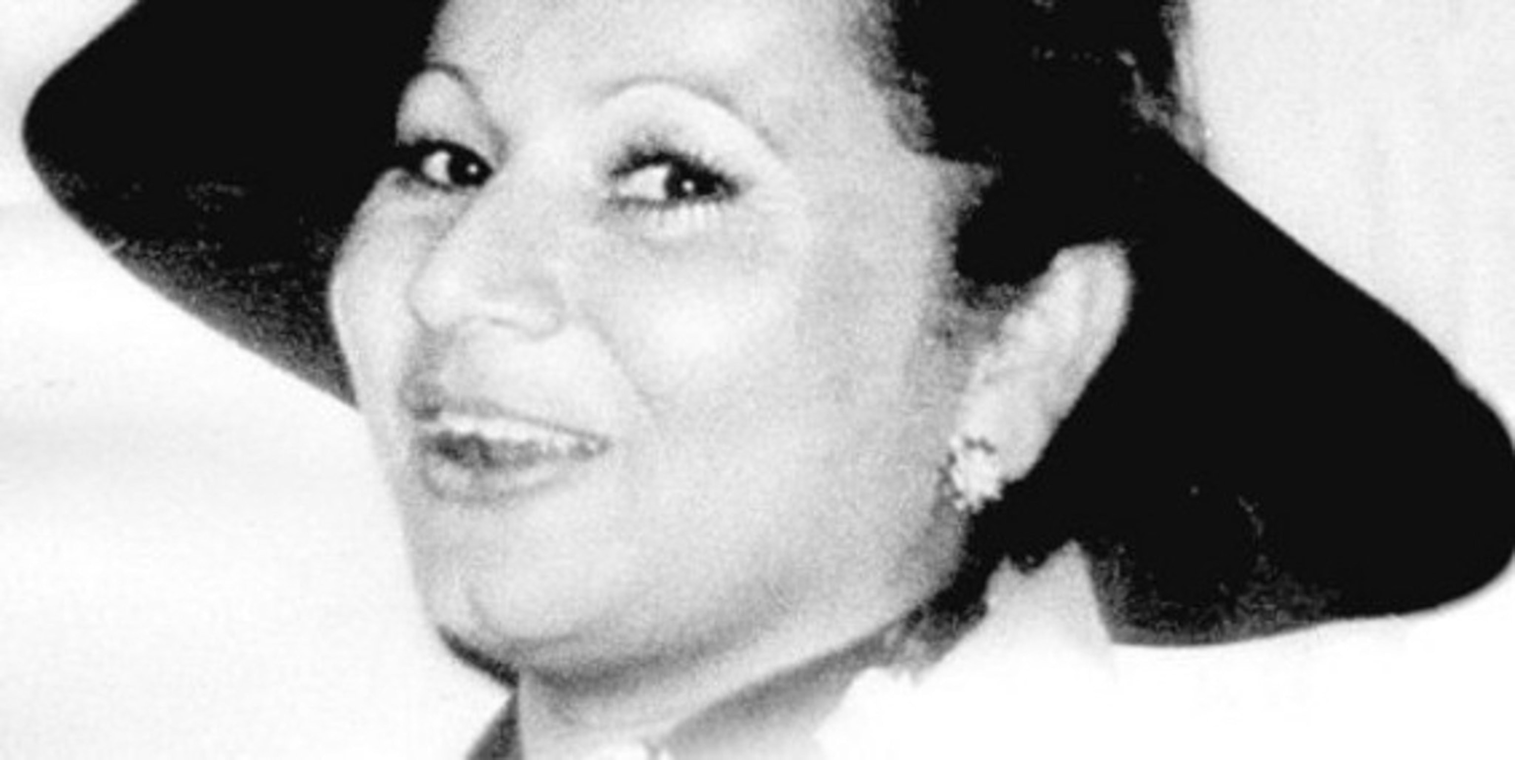 A start white abd black photo of Griselda Blanco the brim of her hat fills a frame on a white background.