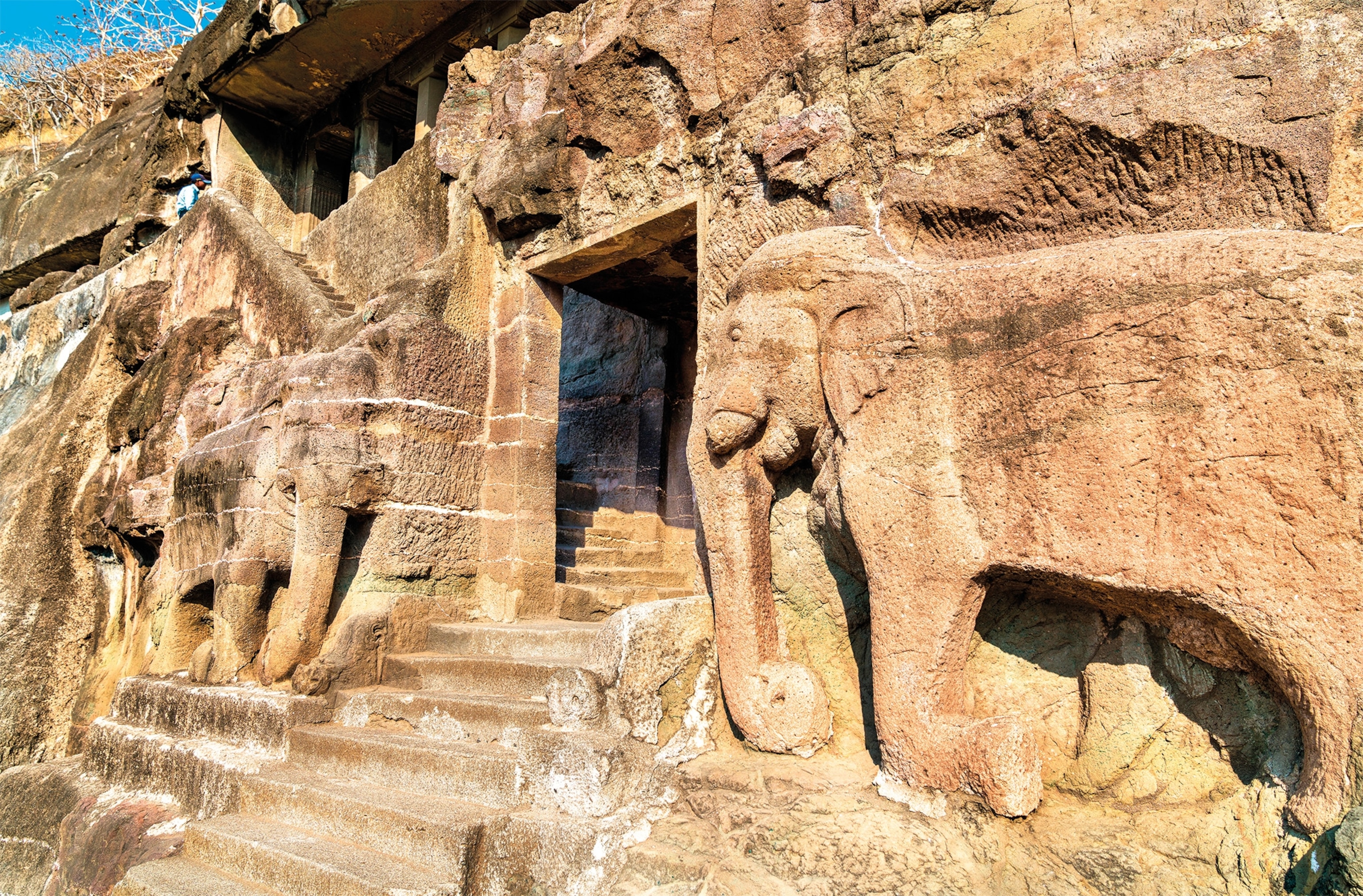 Carved circa the late fifth century A.D., a pair of carefully carved stone elephants flank an entrance to Ajanta Cave 16.