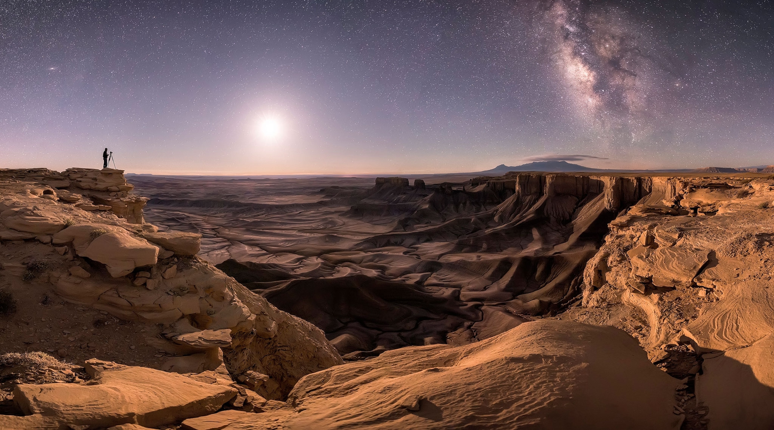 a person in moab, utah under stars.