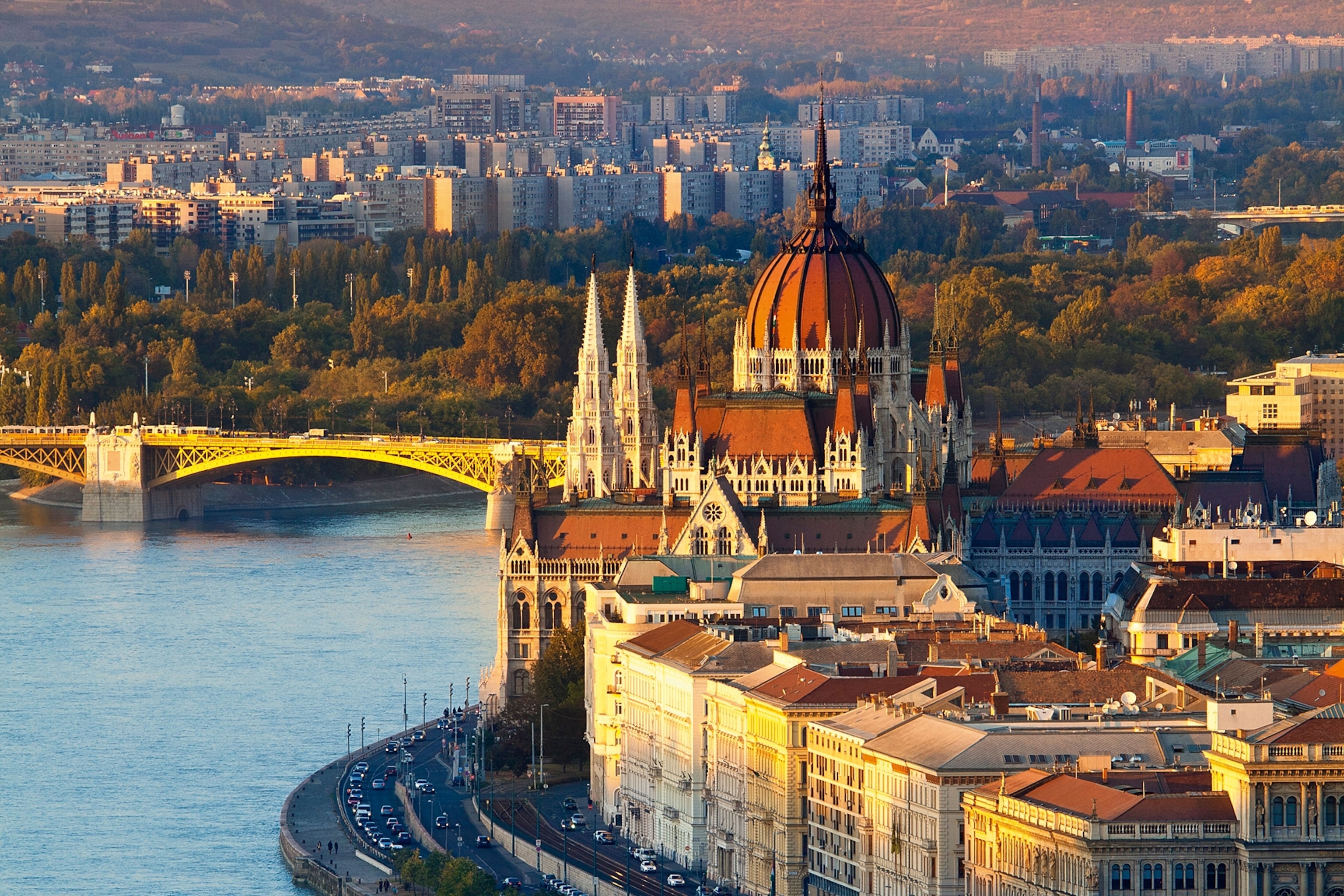A river flowing through a city with cathedral and bridge in the background