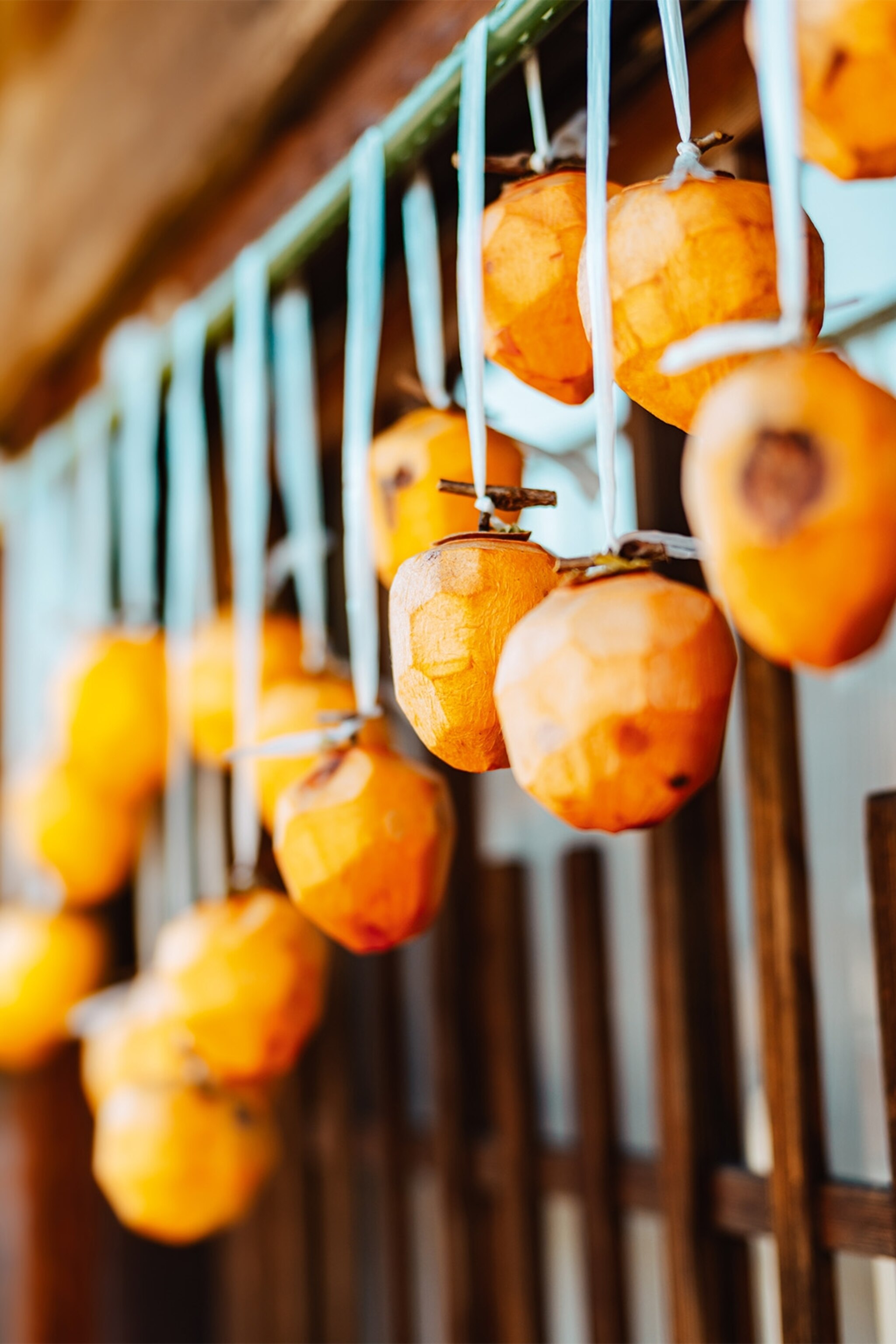 Persimmons hung outside homes to dry in the sun.