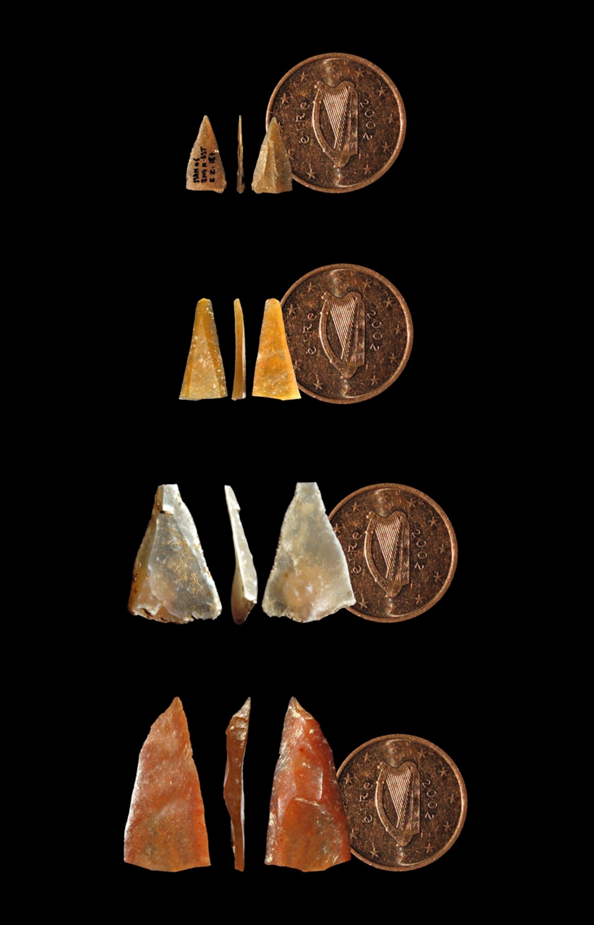 Multiple stone points shown next to a Euro cent.