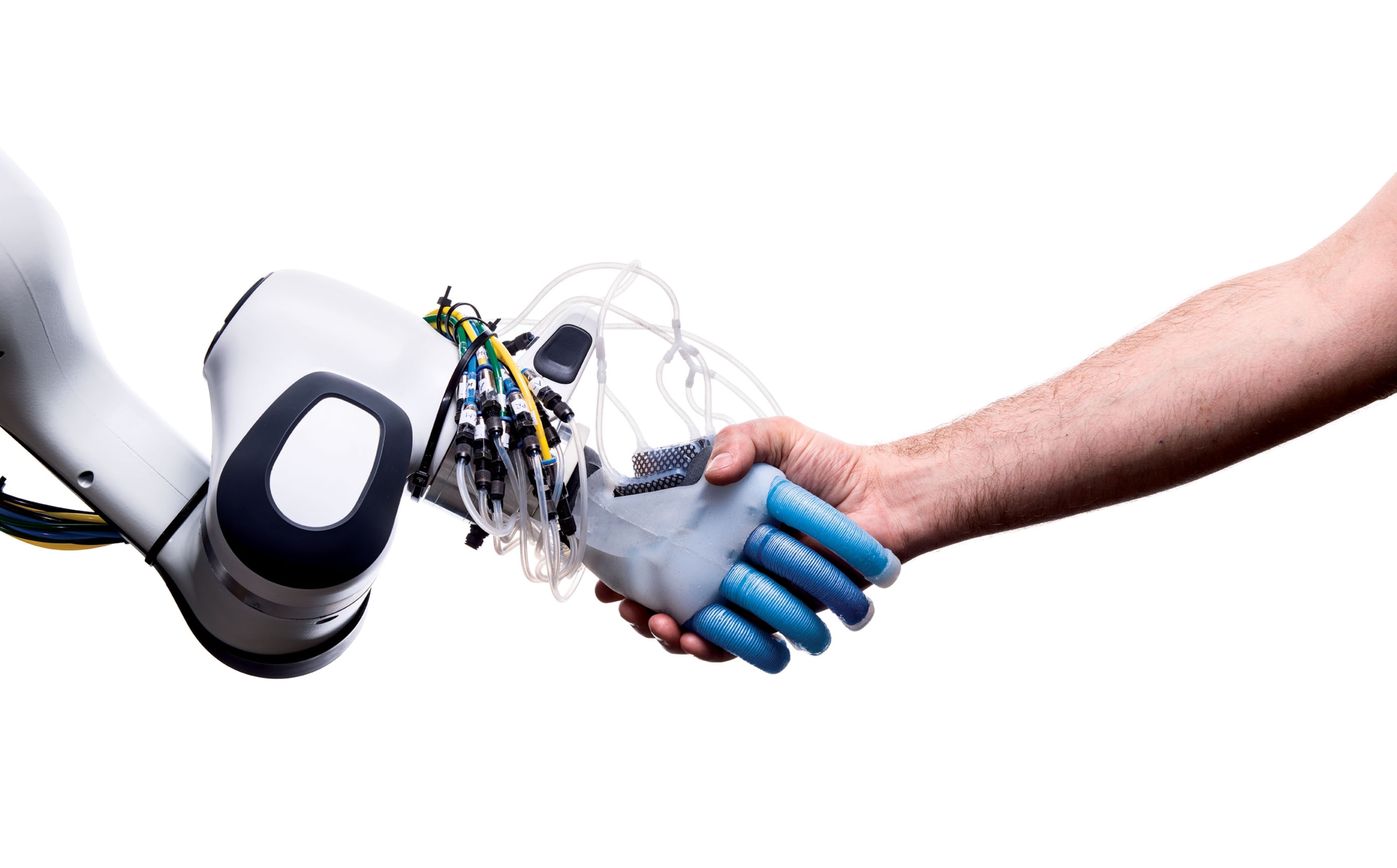 handshake of human and robotic hands.