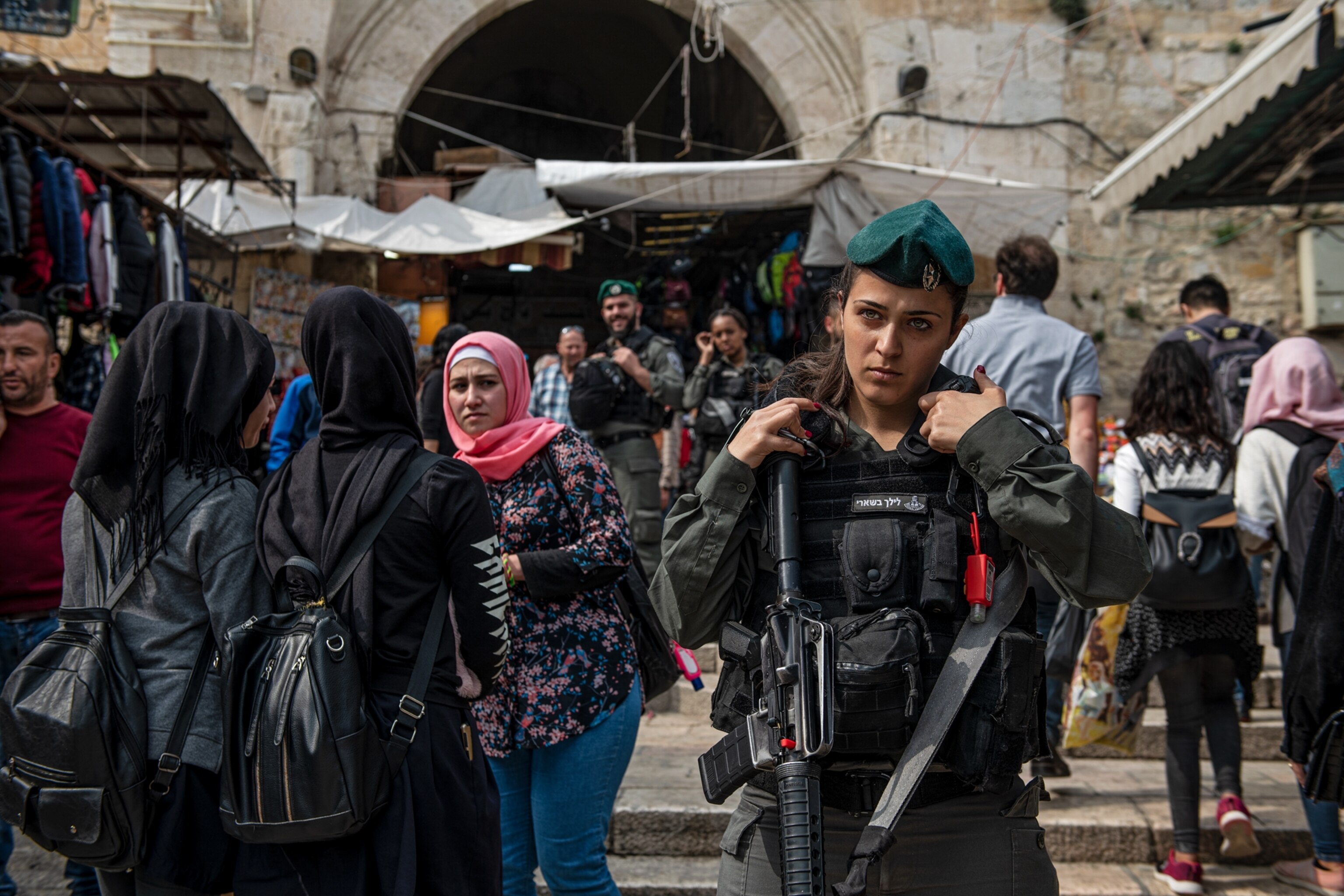 an armed policewoman in a crowd of people