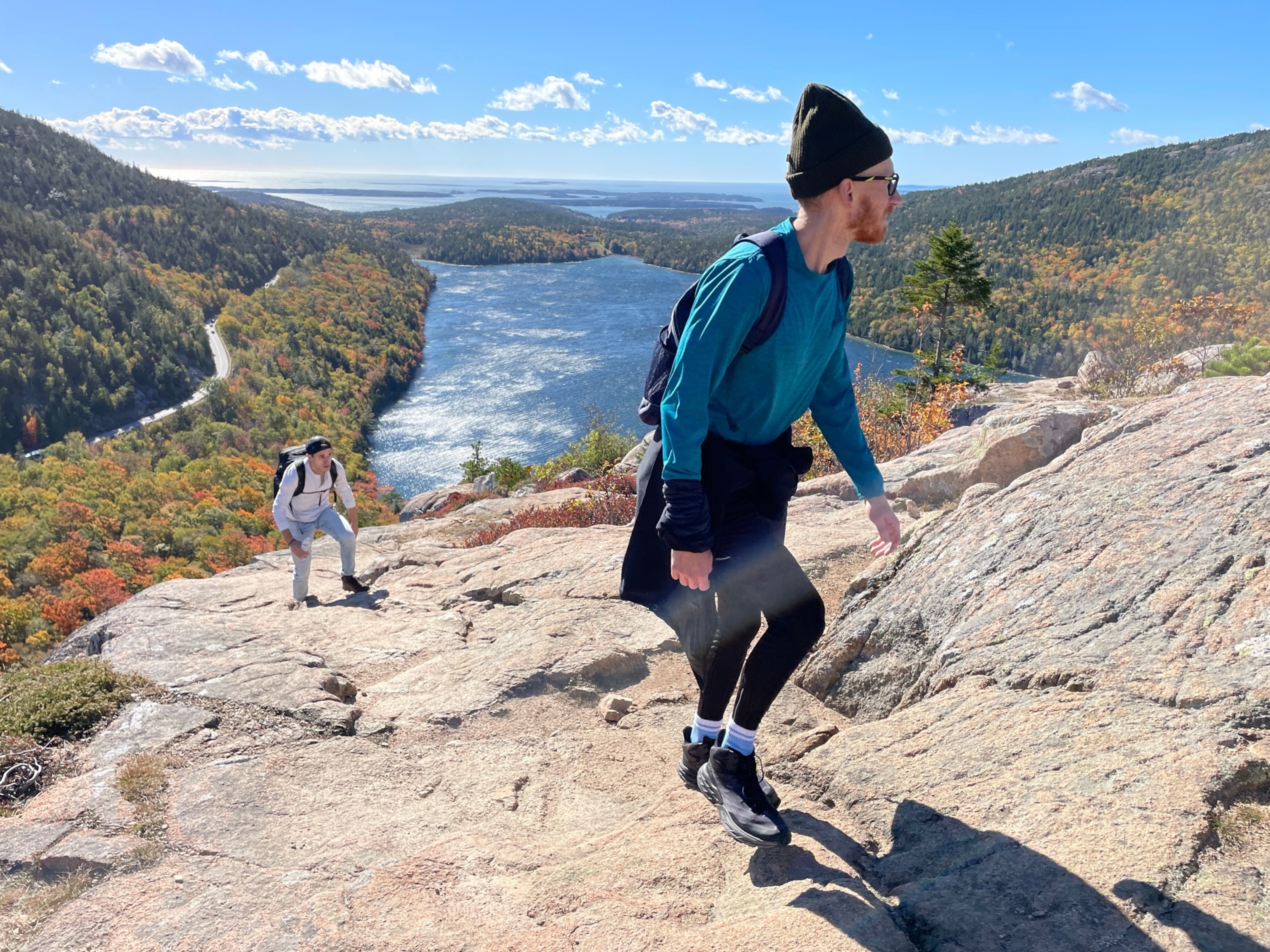Two people walk up a mountain.