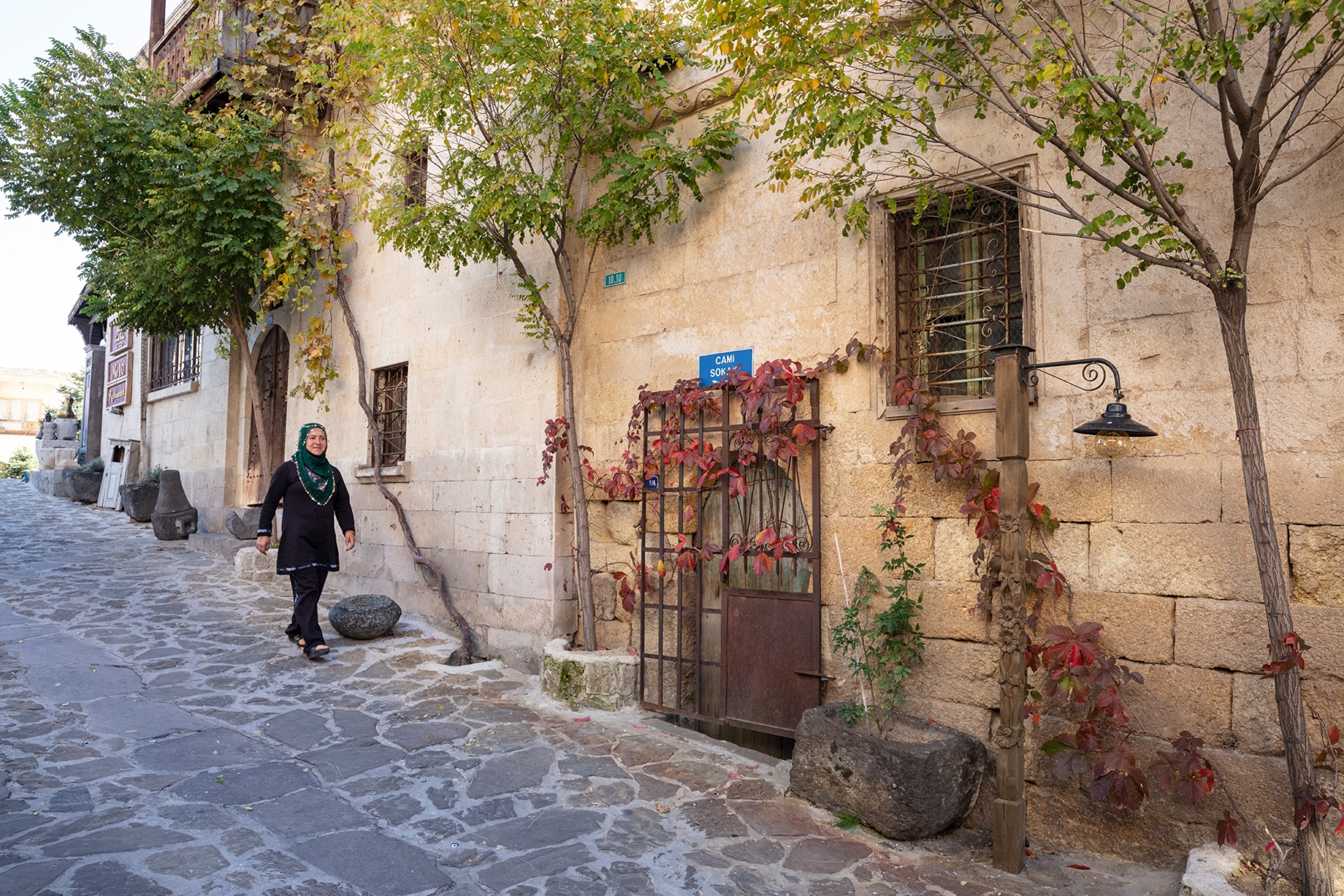 Woman walks down a stone street
