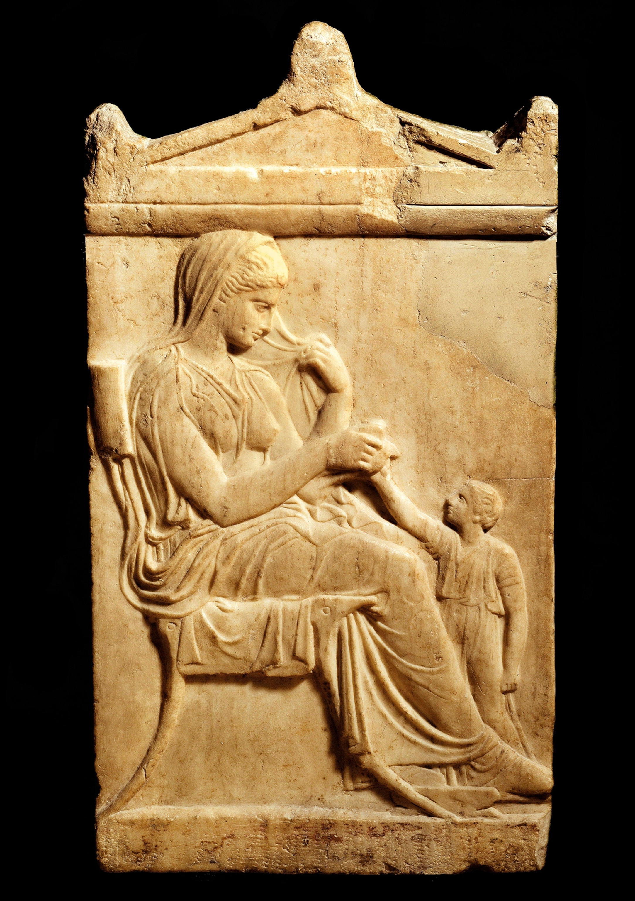 A mother and child share a quiet moment on an Athenian funerary stela from the fifth century B.C.