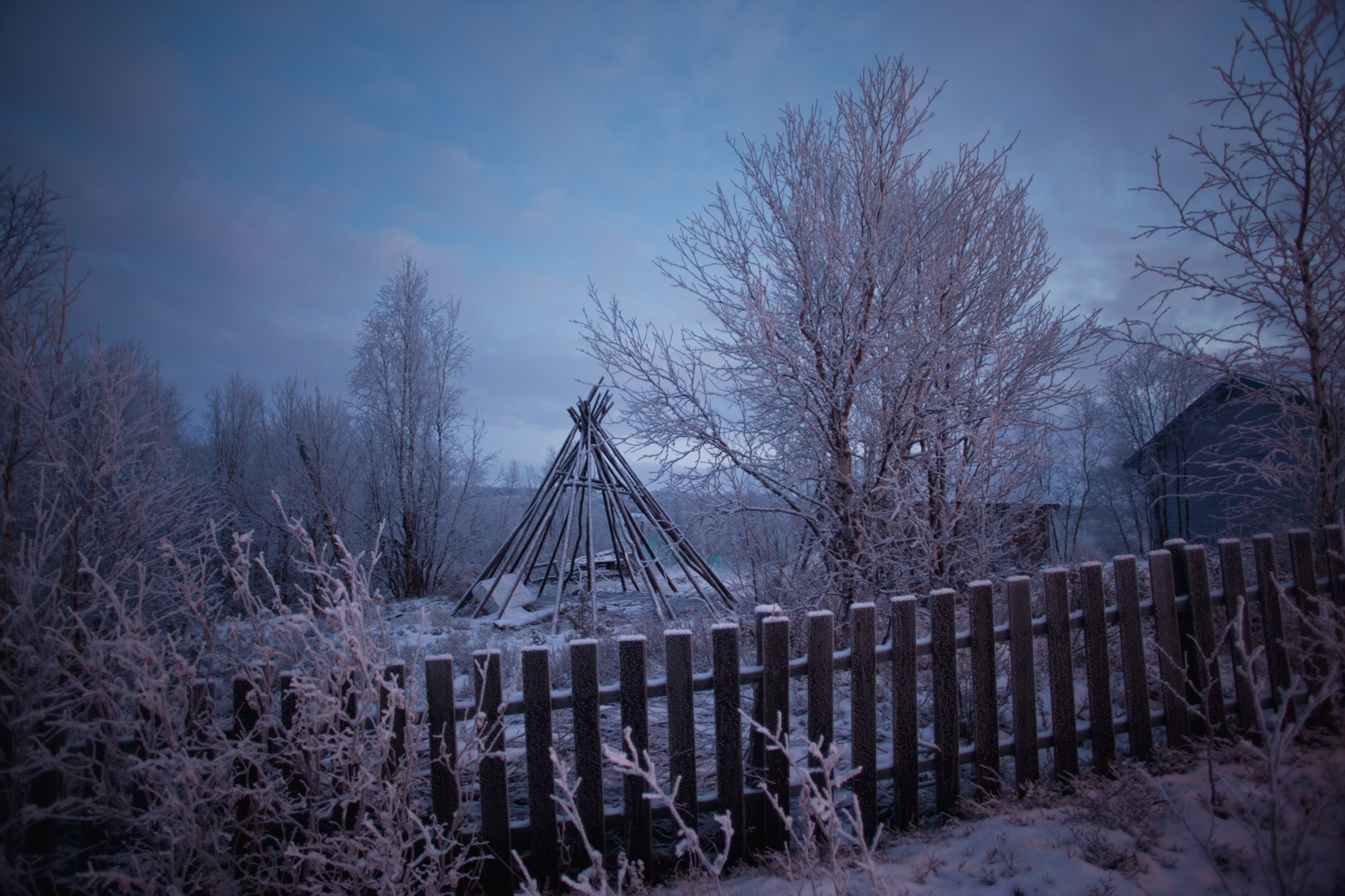 frames of a lávut sitting in a Sami yard