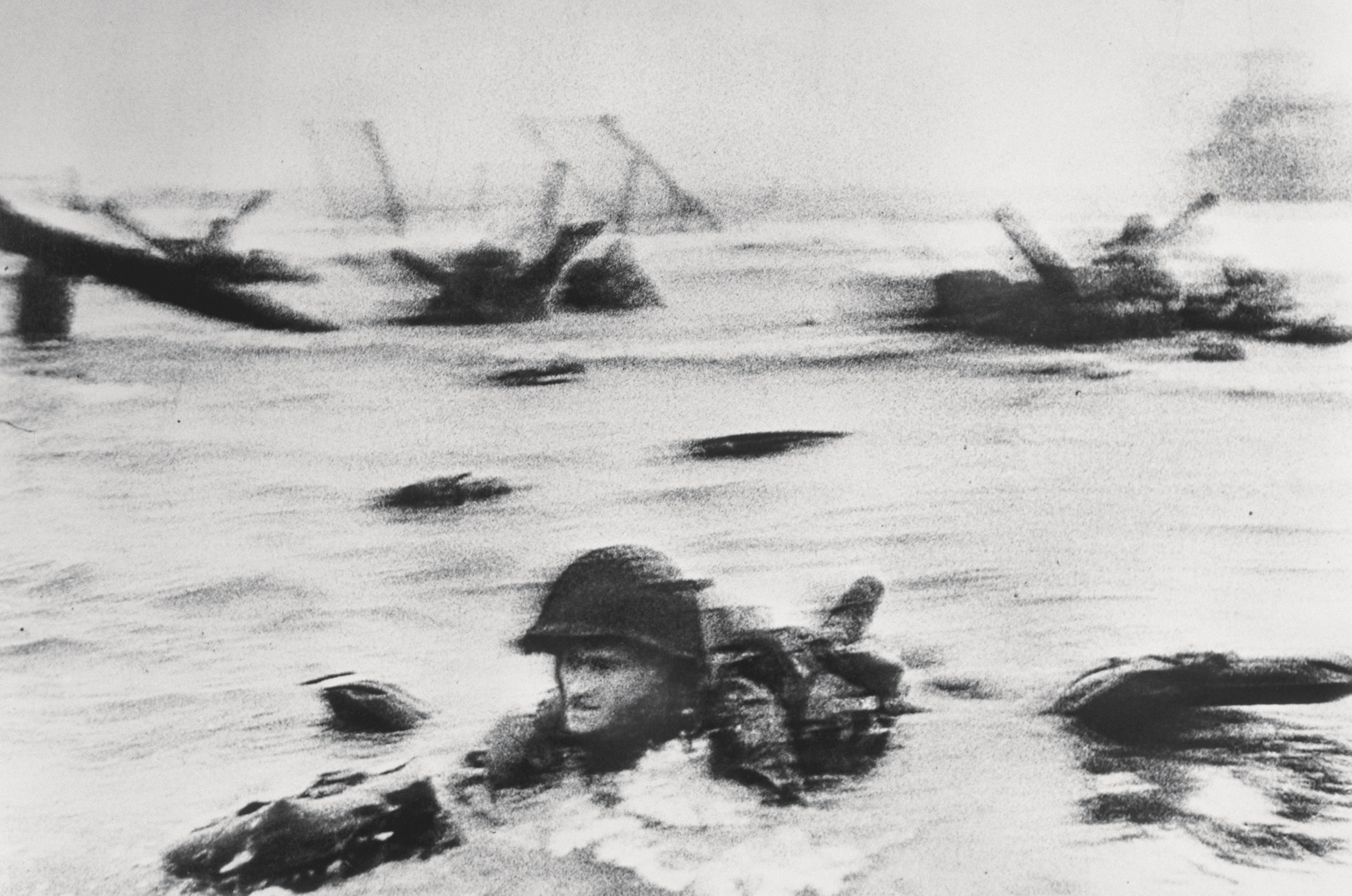 a soldier wading through water