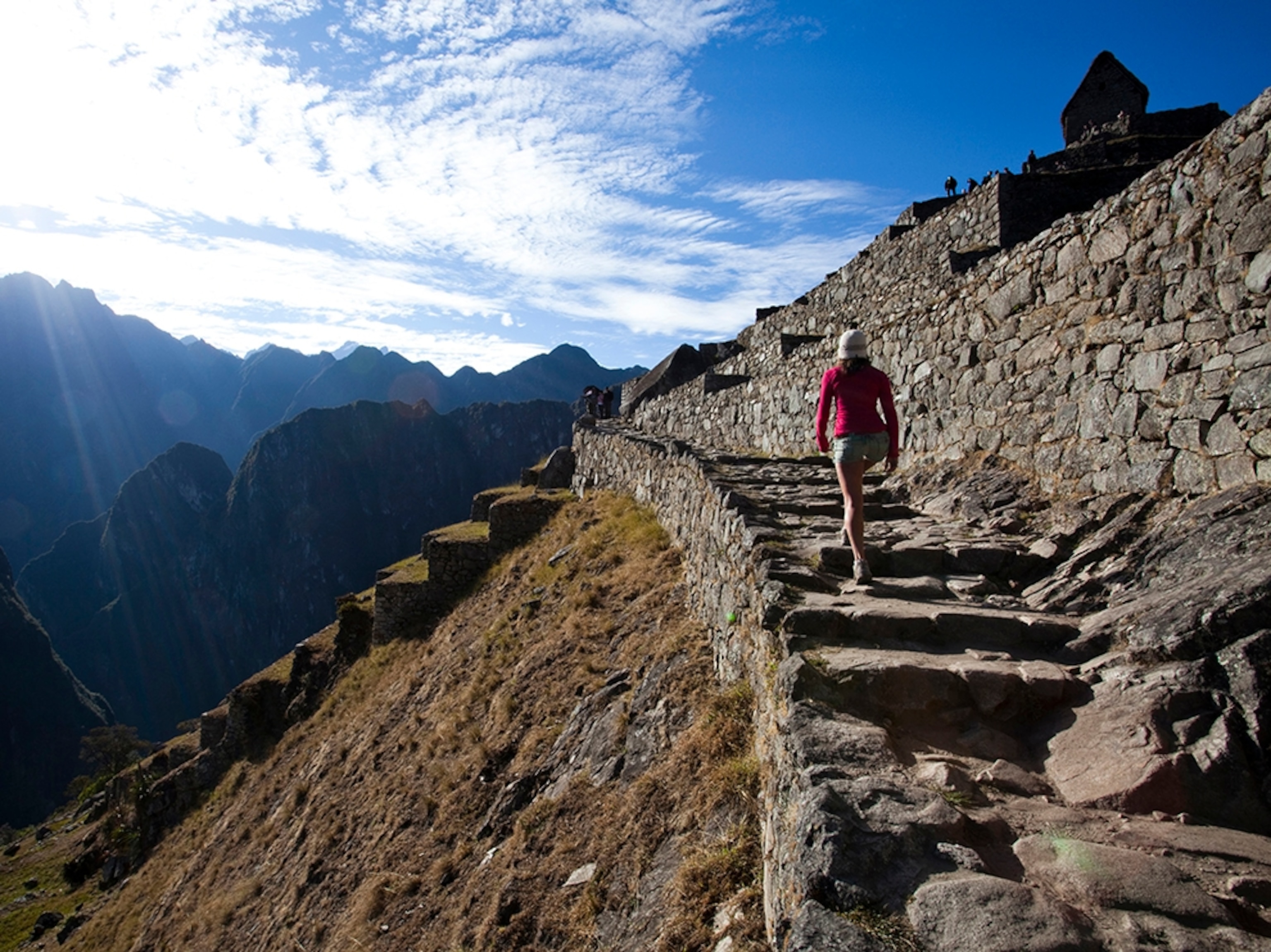 a tourist walking on stairs at Machu Picchu