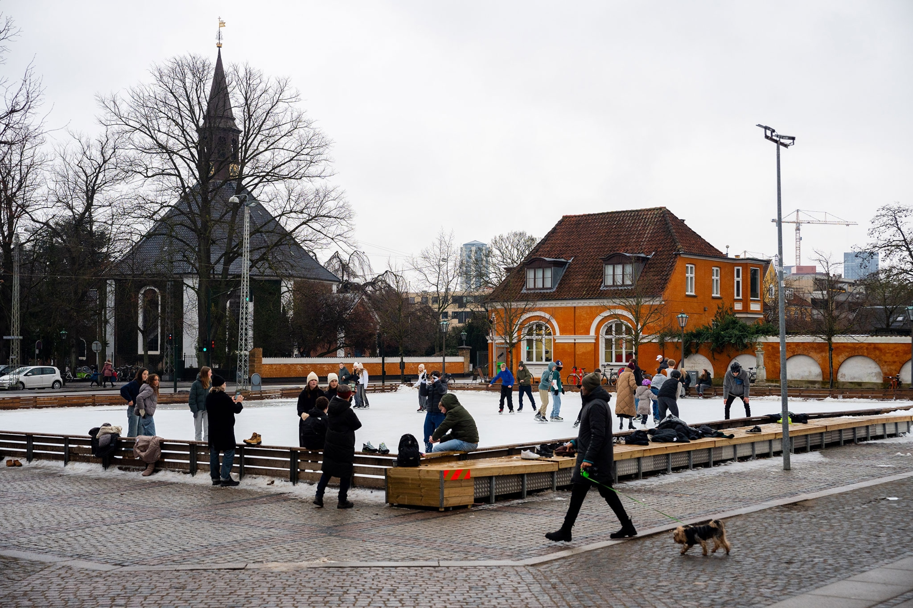 Ice skaters are seen on a small rink in the city of Copenhagen.