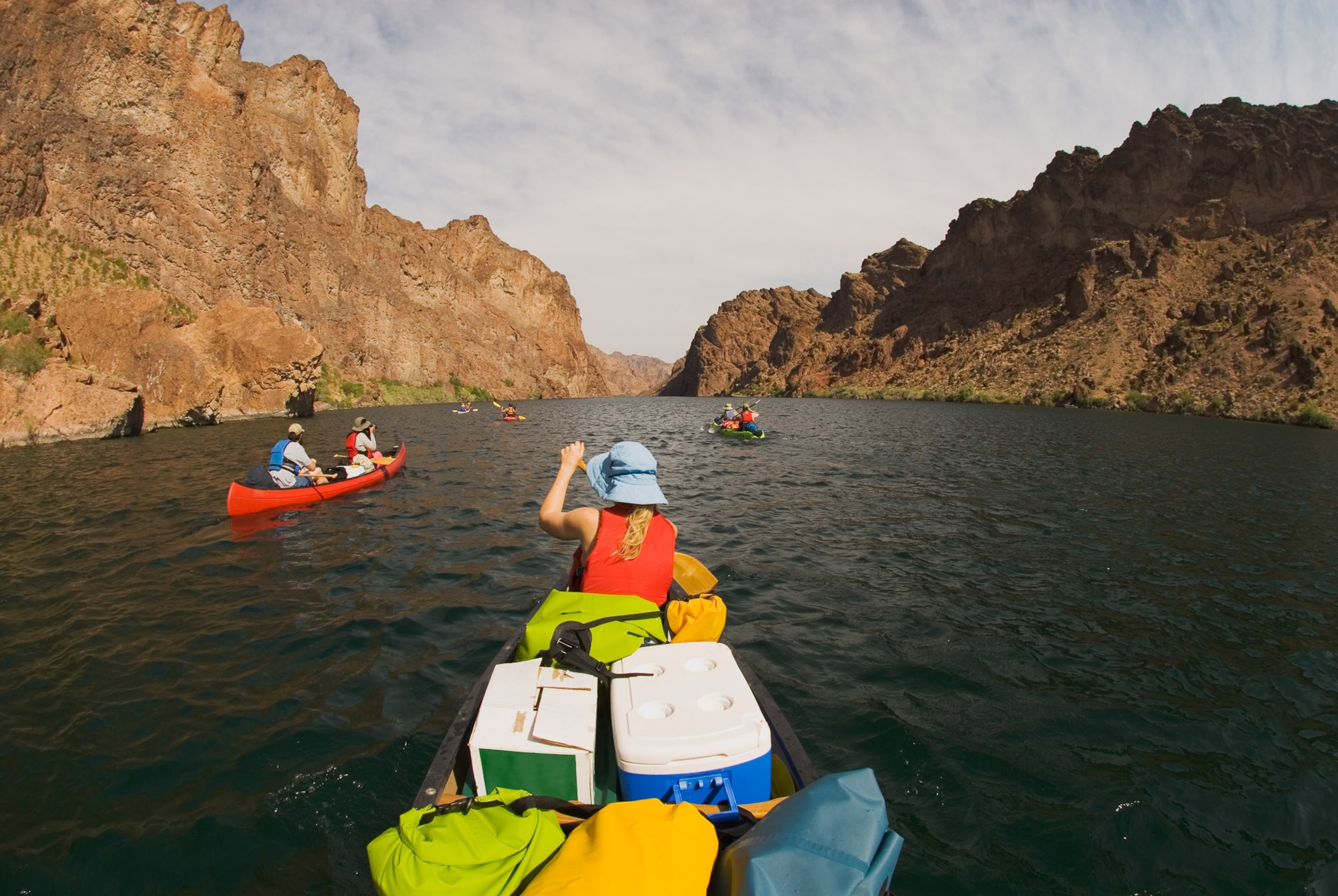 A group paddles along the river