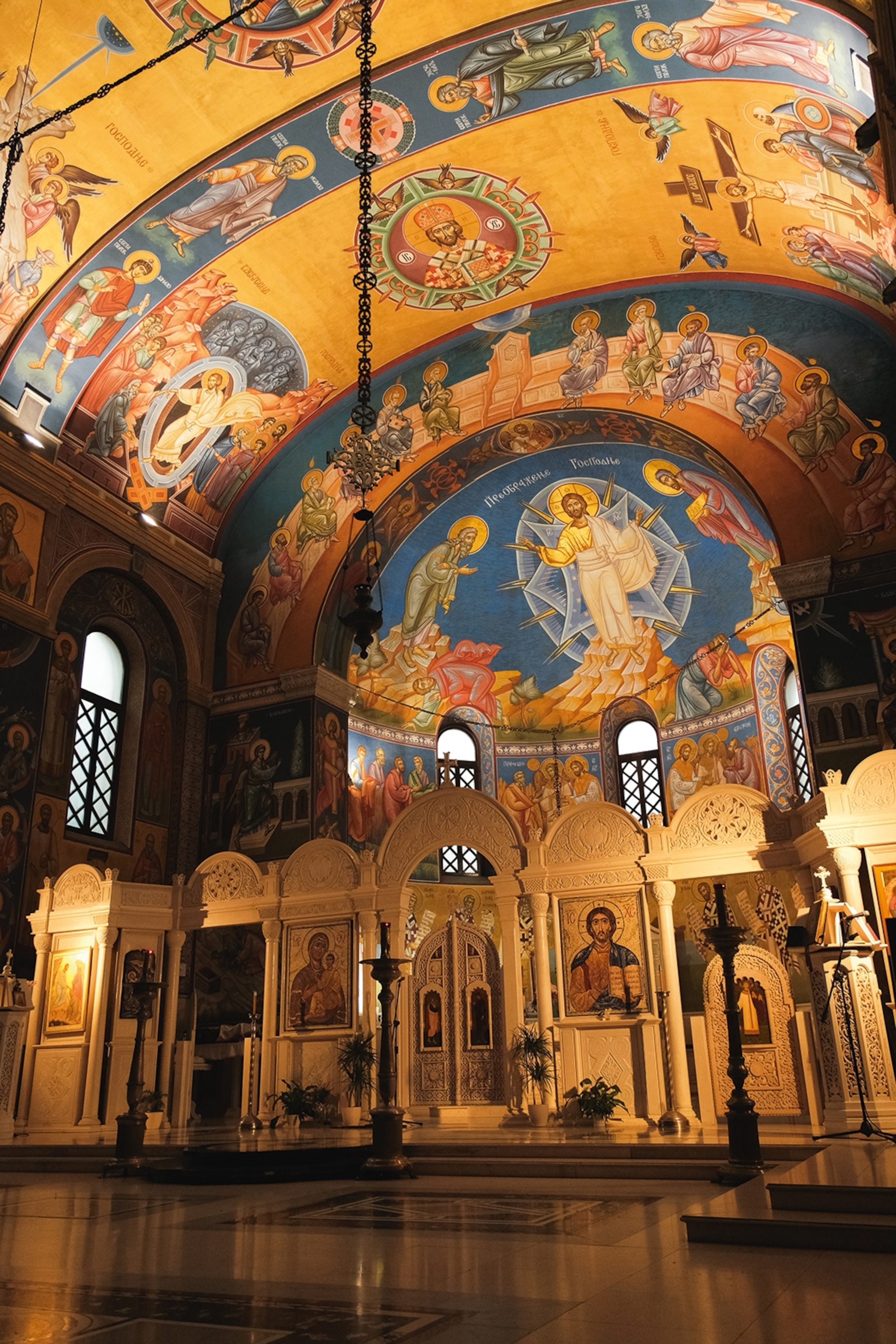 Interior of a church with intricately painted murals on a dome ceiling