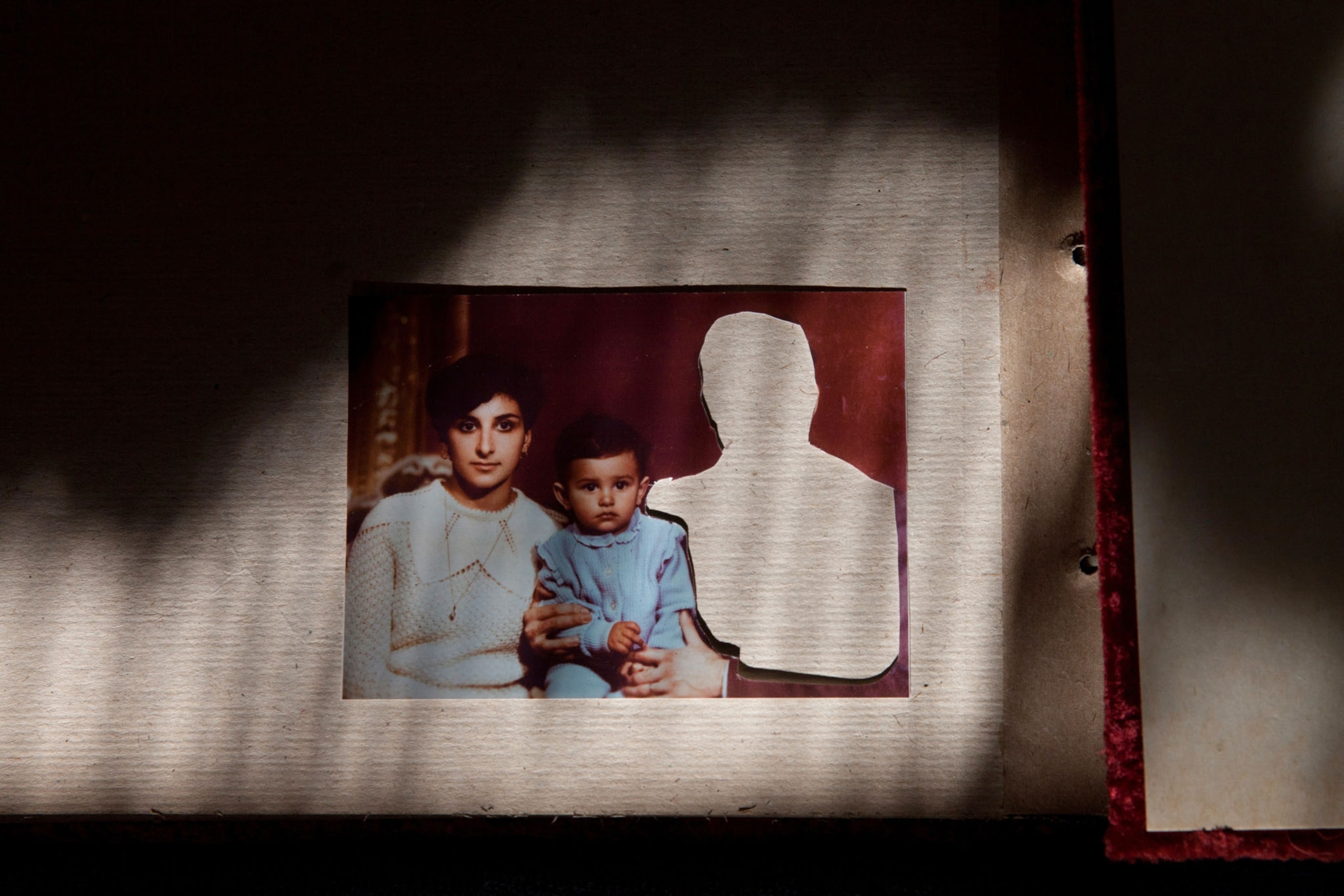 color portrait of a young woman with child and white space in shape of human figure next.