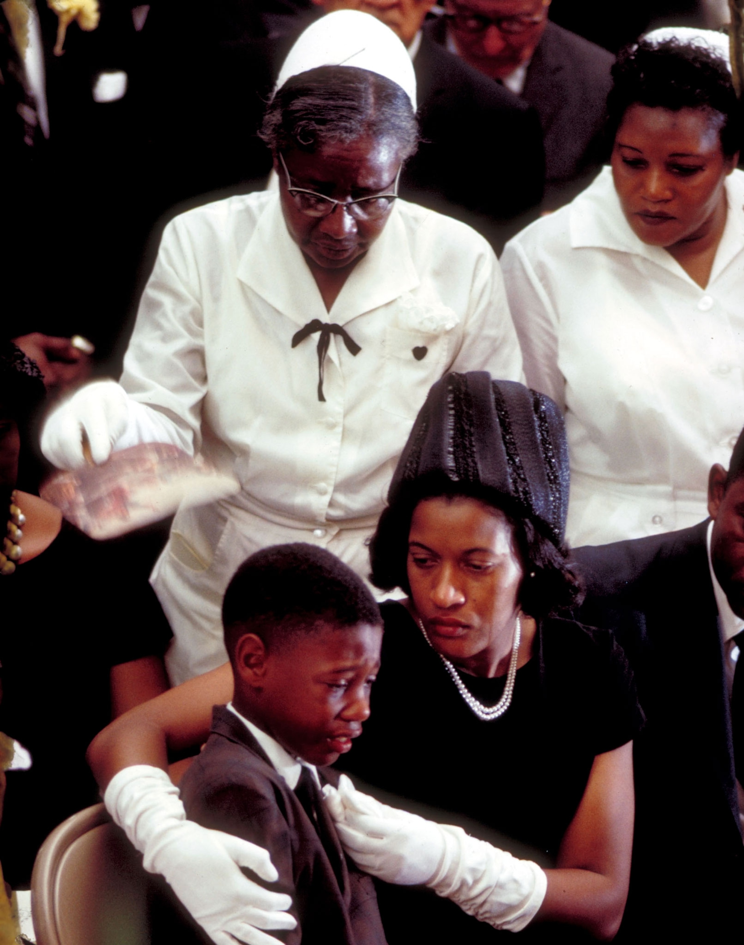 a woman comforting her crying son