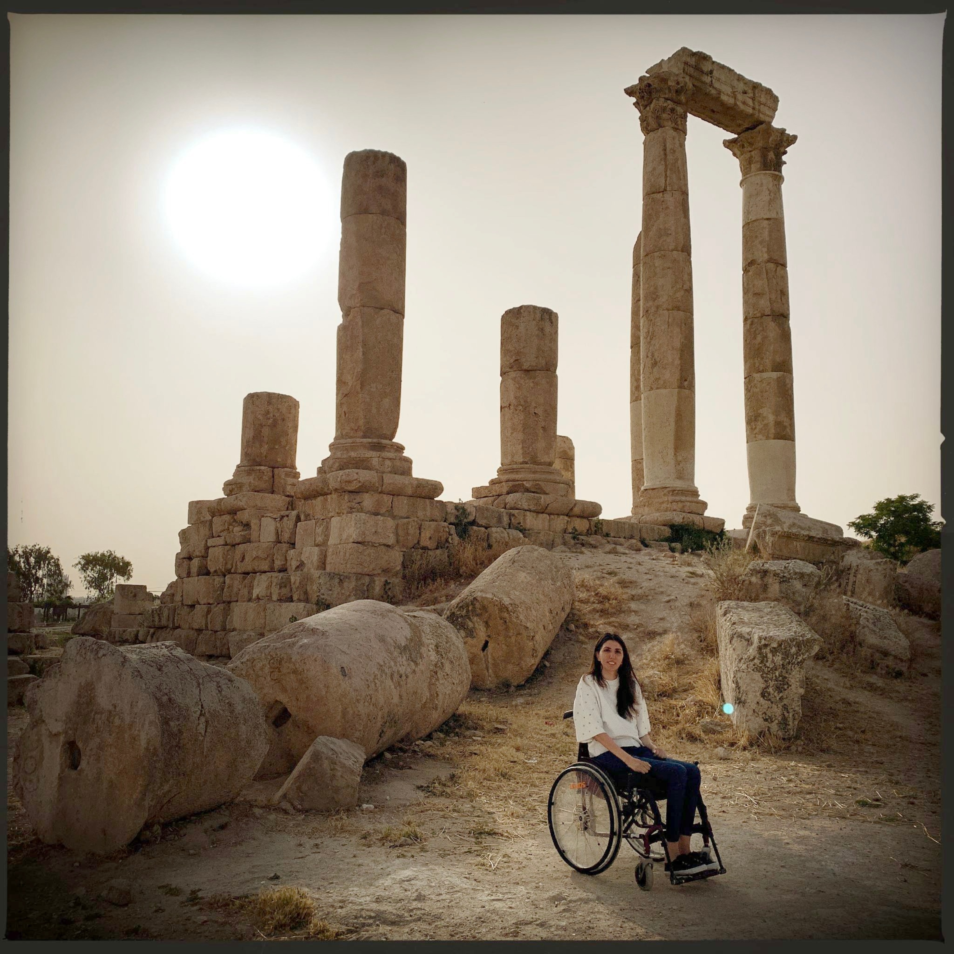young woman in wheelchair at ancient site