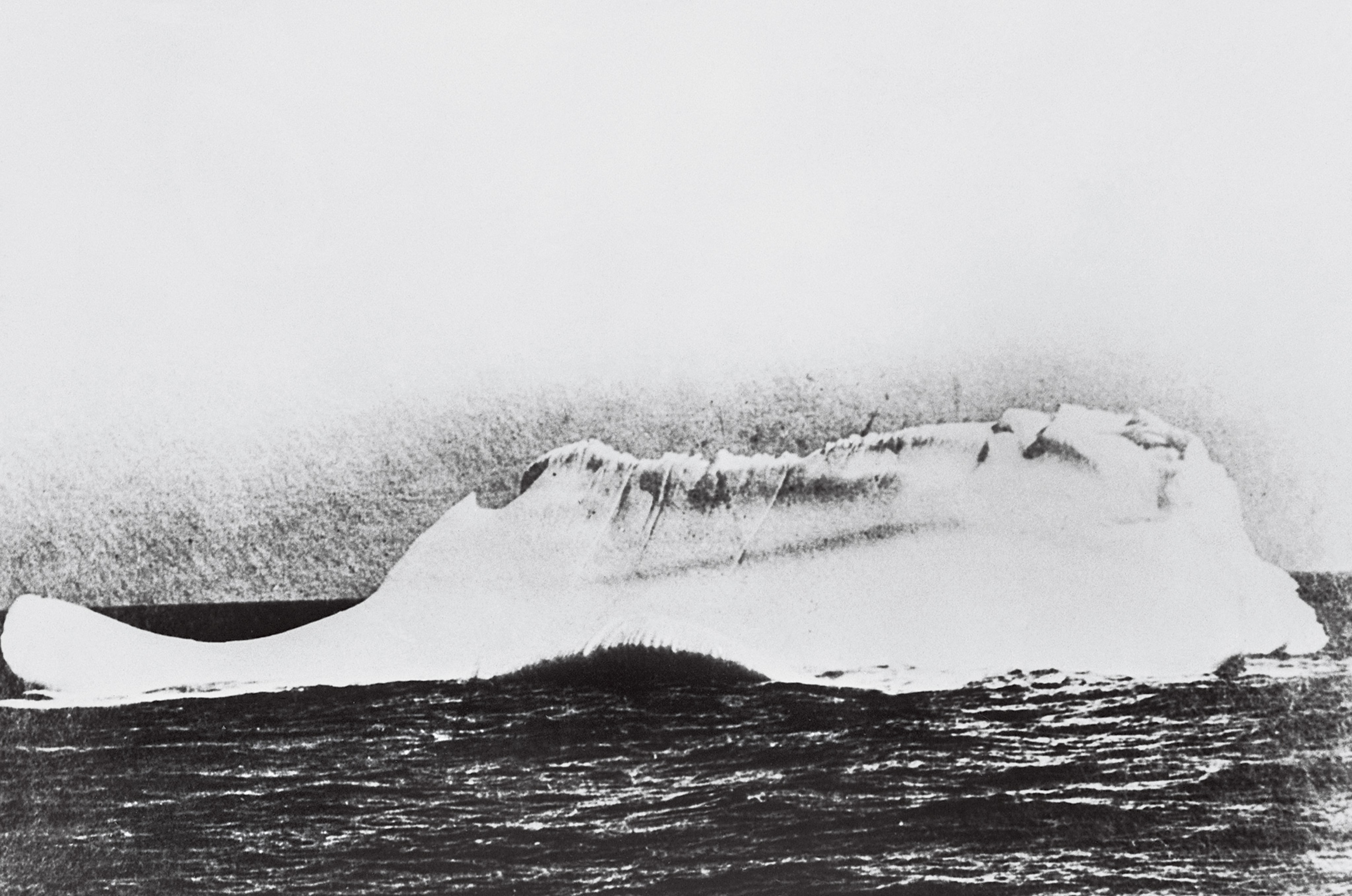 Taken by Captain William de Carteret of the cable ship Minia, which was sent to retrieve bodies and debris after the Titanic sank, this image is believed to show the iceberg—with a streak of red paint across it—with which the great ship collided.