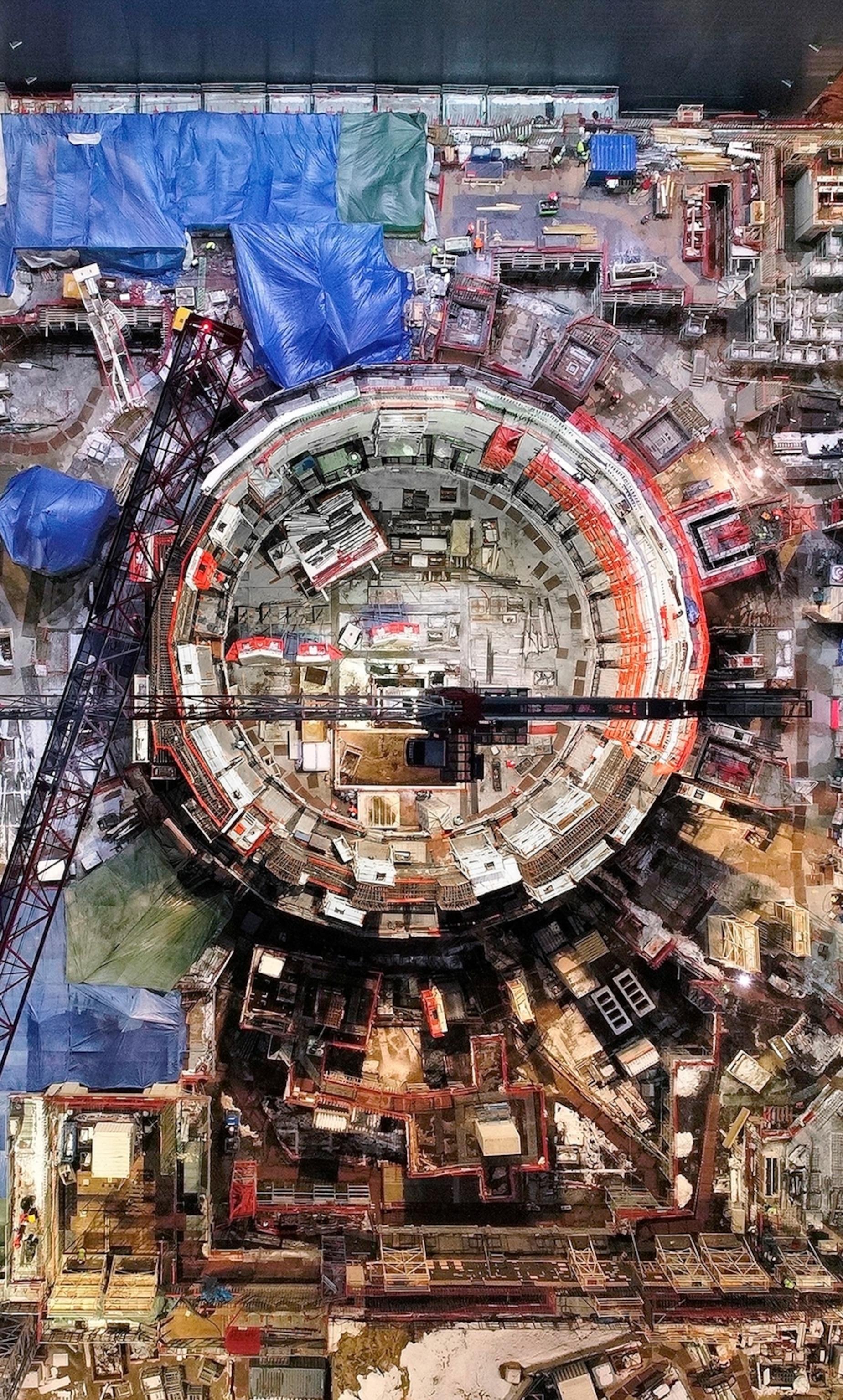 aerial of construction site with round structure in the middle.
