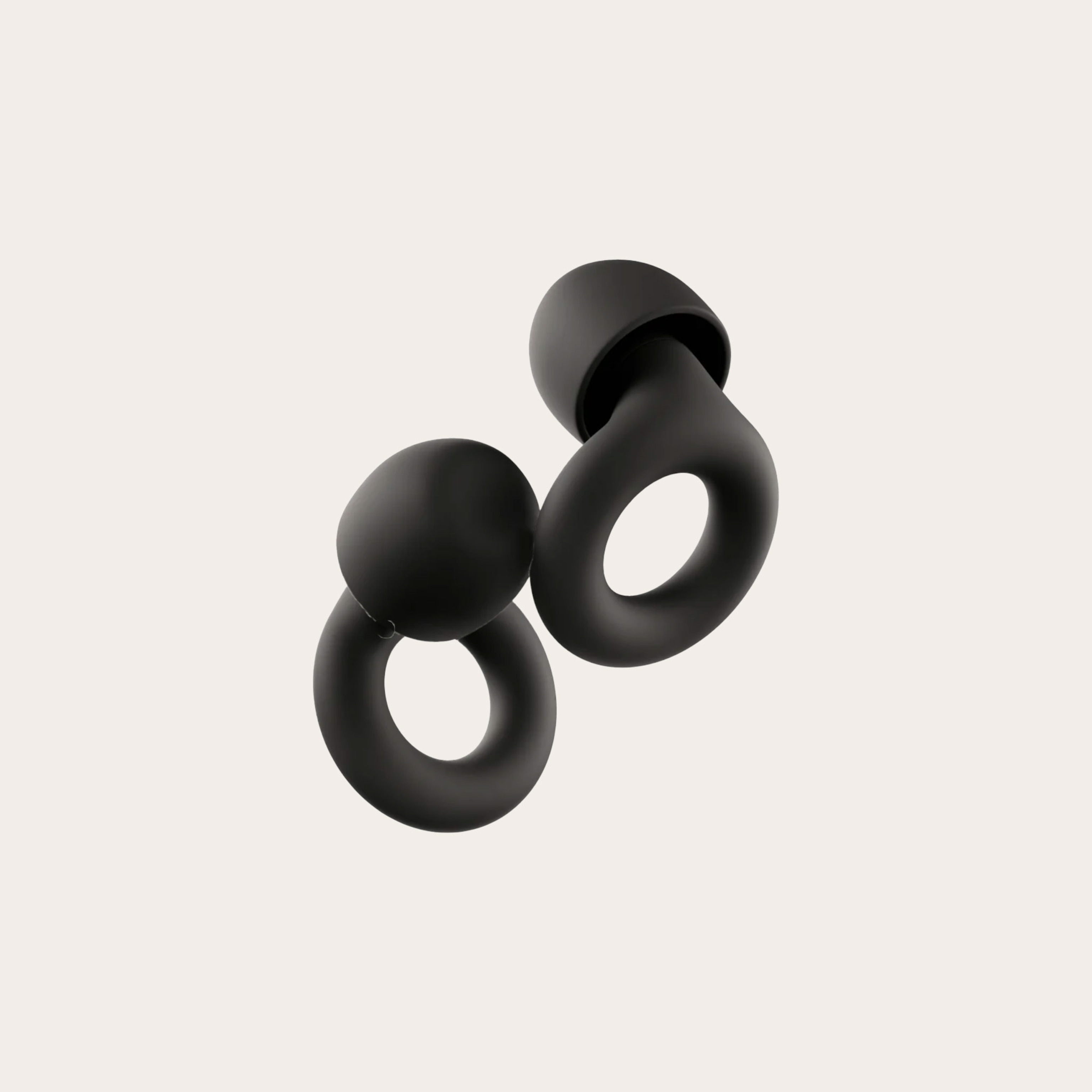 Two black ear plugs placed on a tan background