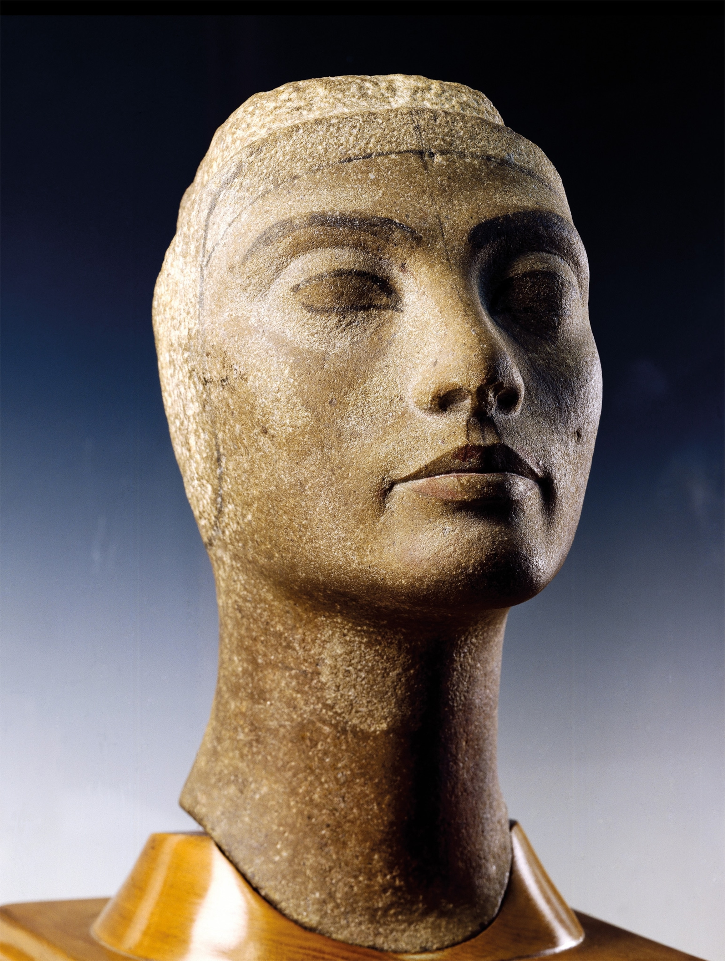 In this unfinished bust of the queen, Nefertiti’s features are softly rendered, but dark pigments have been used to emphasize her brows and eyes.