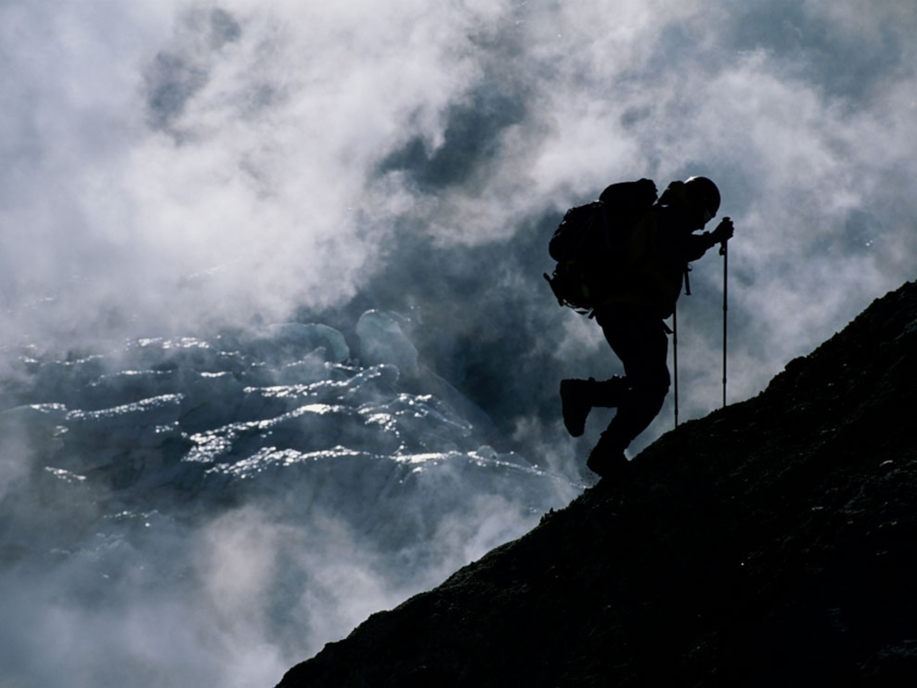 Hiker climbing volcano in Kamchatka, Russia