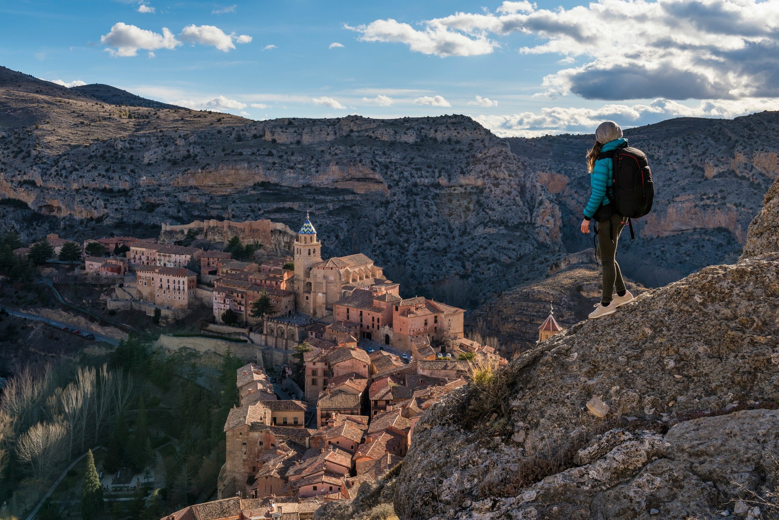 A hiker looks out across the town of Albarracín