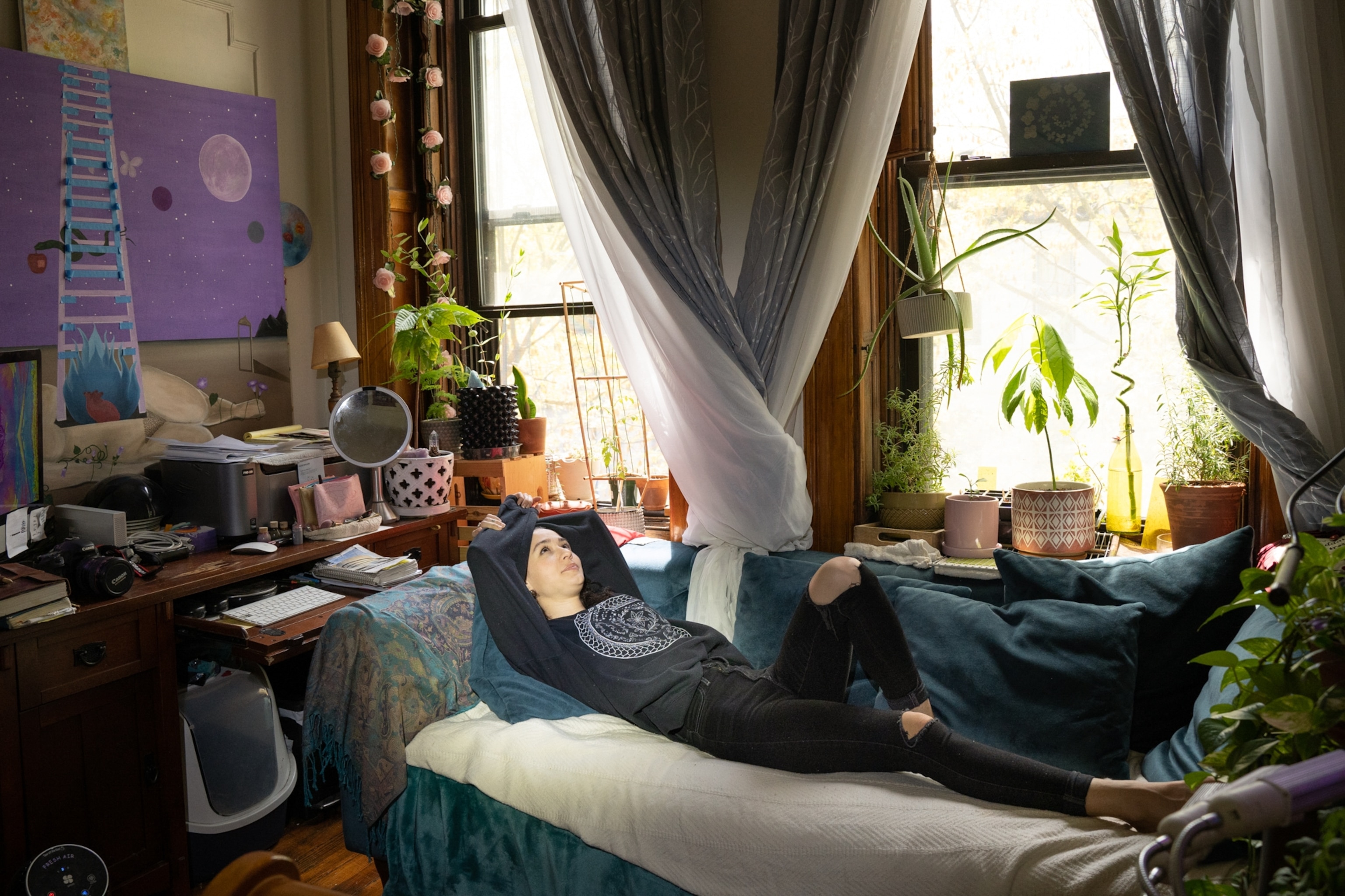 Ariel lies alone on her couch.