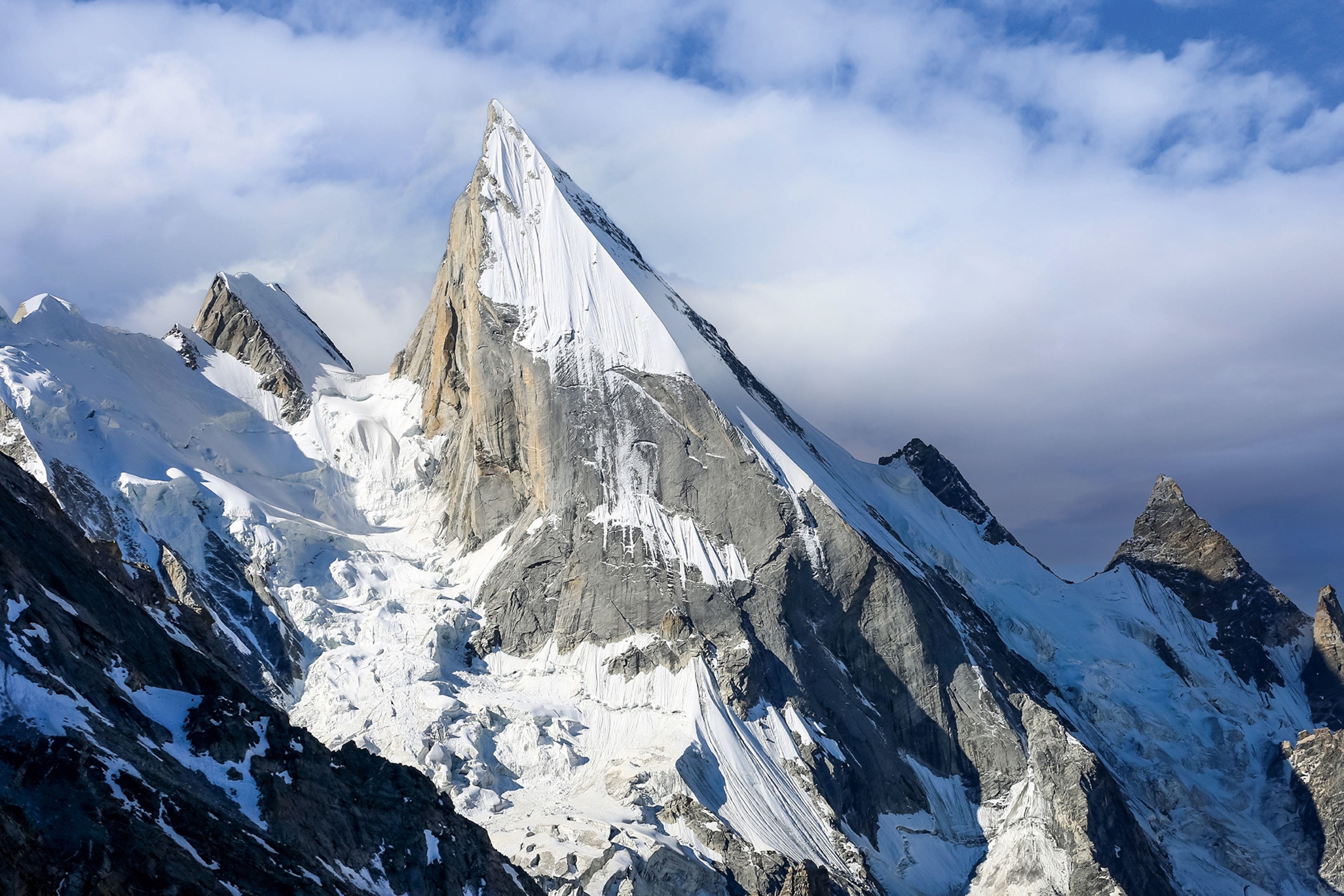 Arial shot of a snowy mountainous landscape.