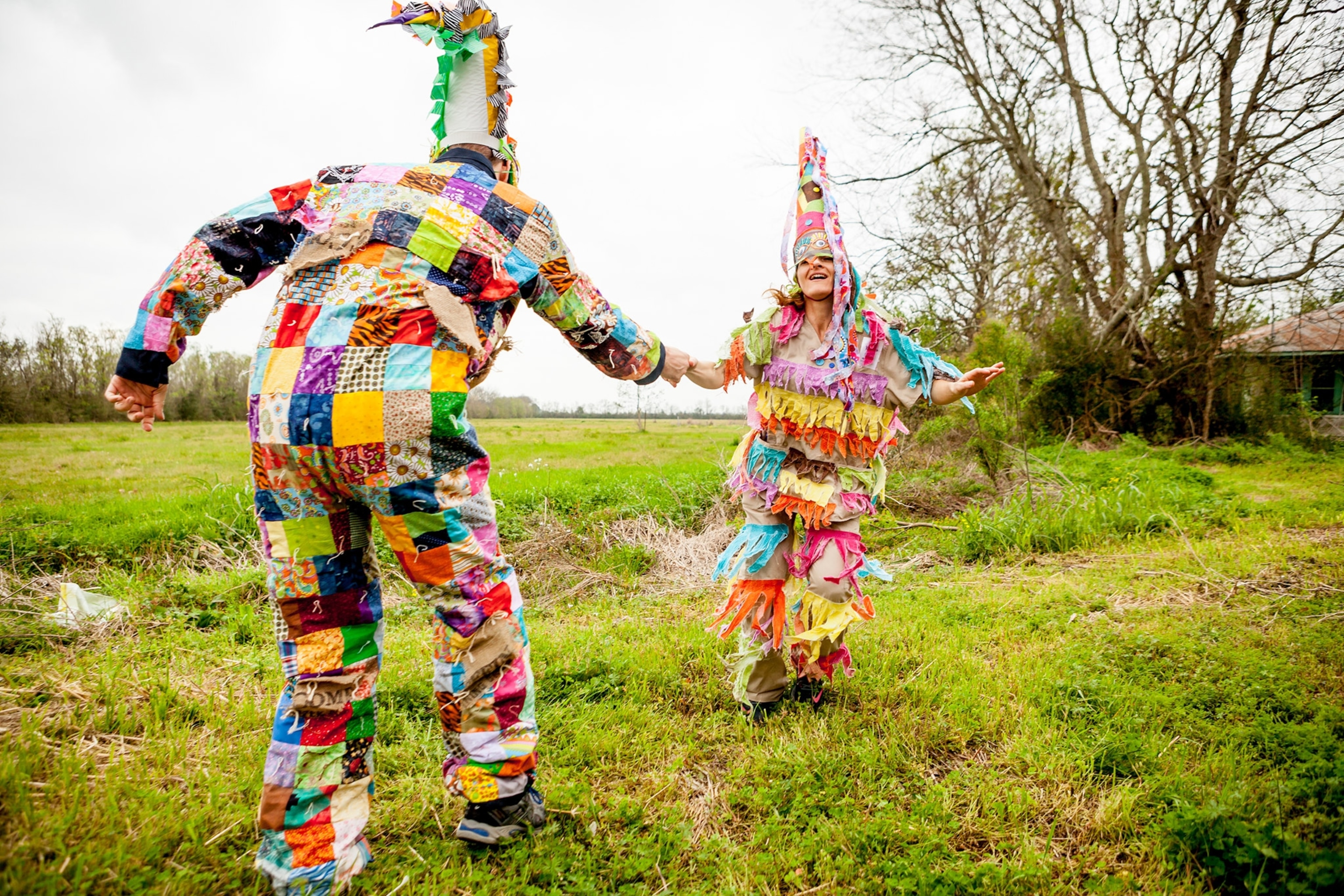 people walking through the fields at the Courir de Mardi Gras celebration