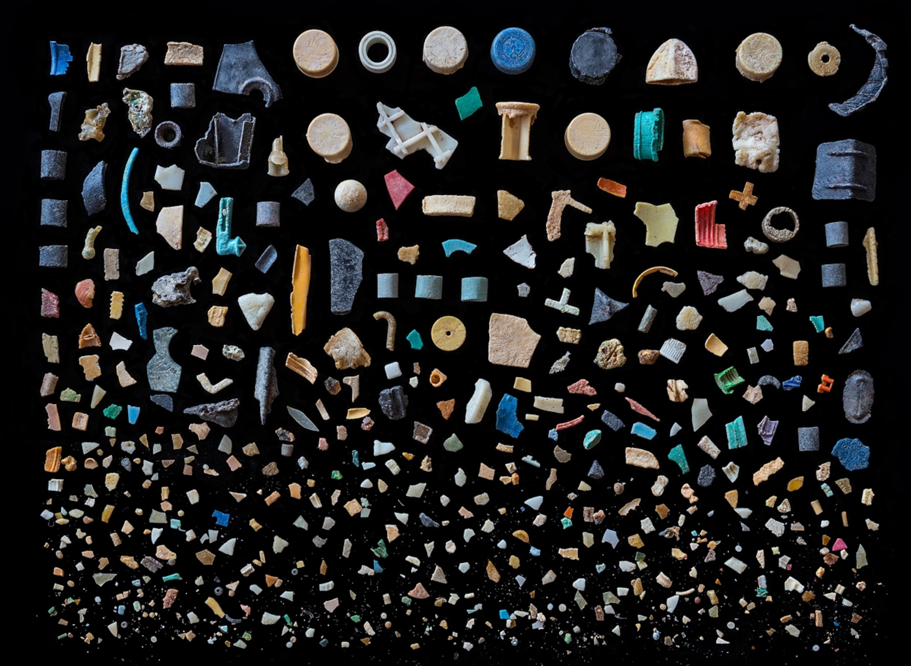 various plastic pieces sorted and laid out on a black background
