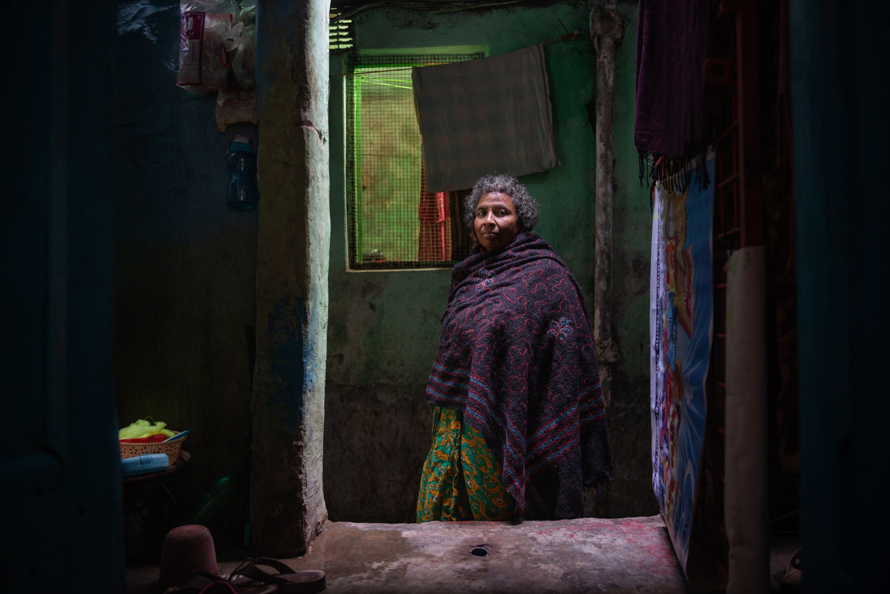 a woman posing for a portrait looking through a window