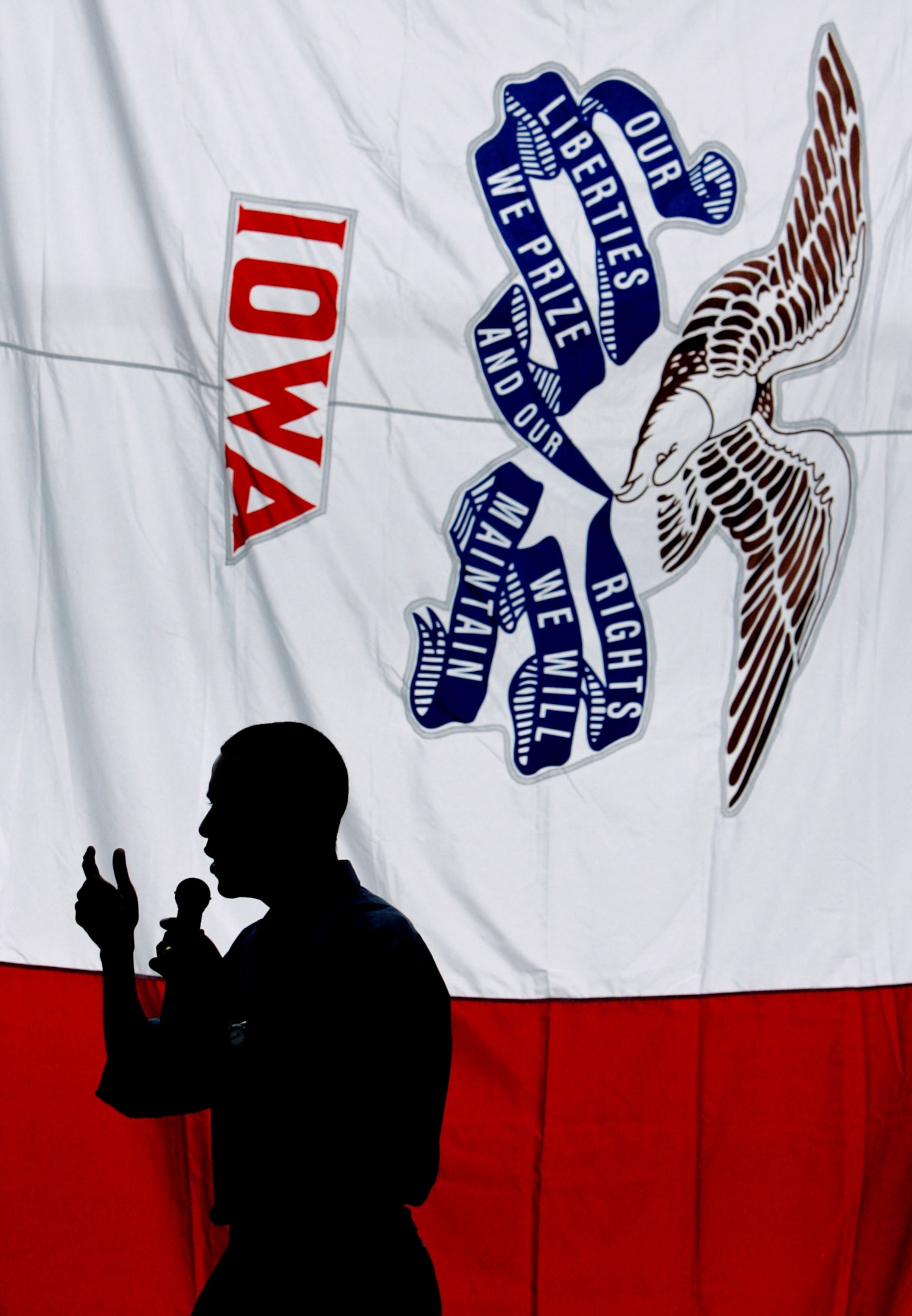 presidential hopeful Barack Obama speaking in front of an Iowa flag in 2007
