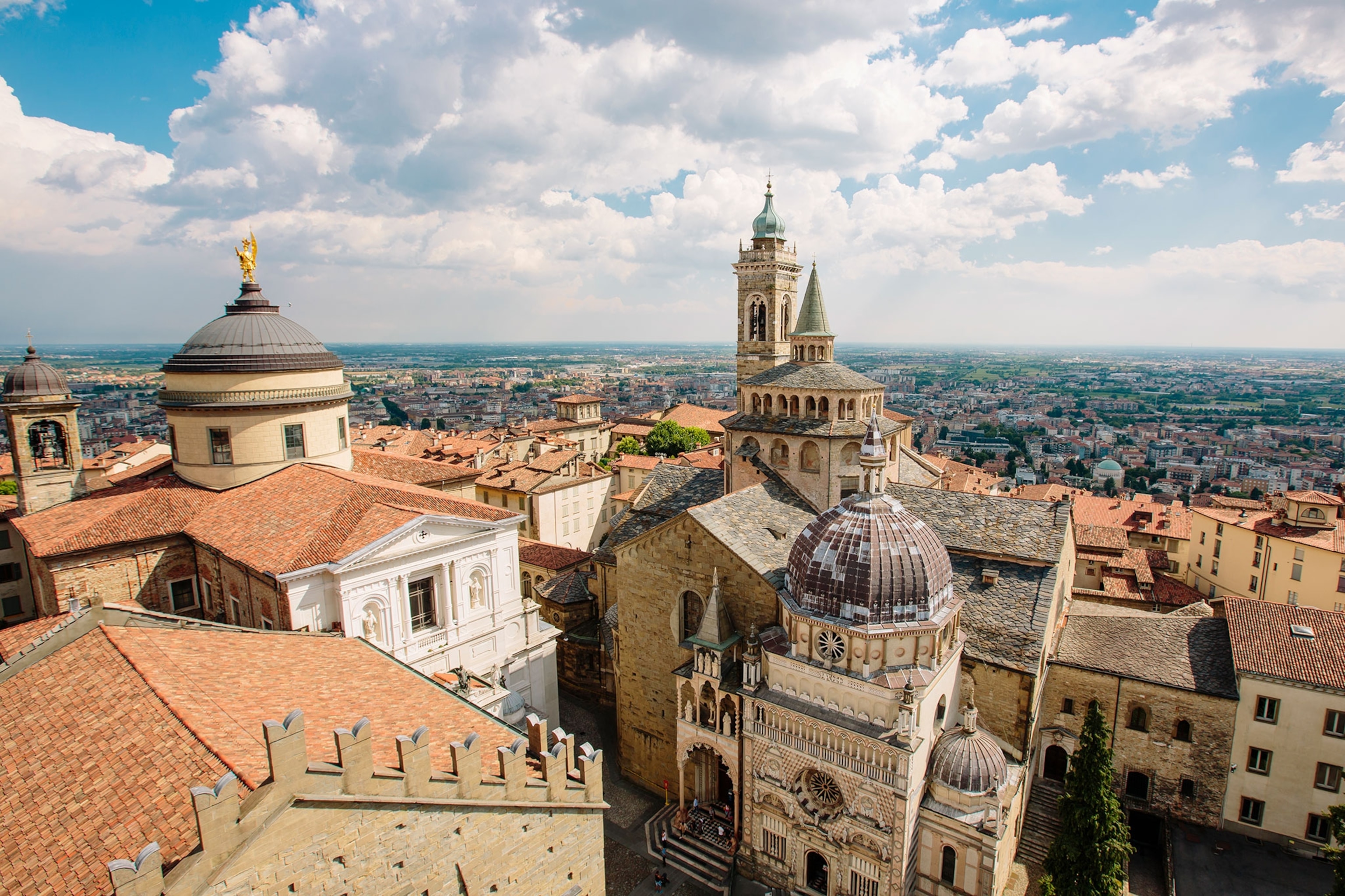 Aerial view of an Italian basilica with the rest of the city in the background on a cloudy day.