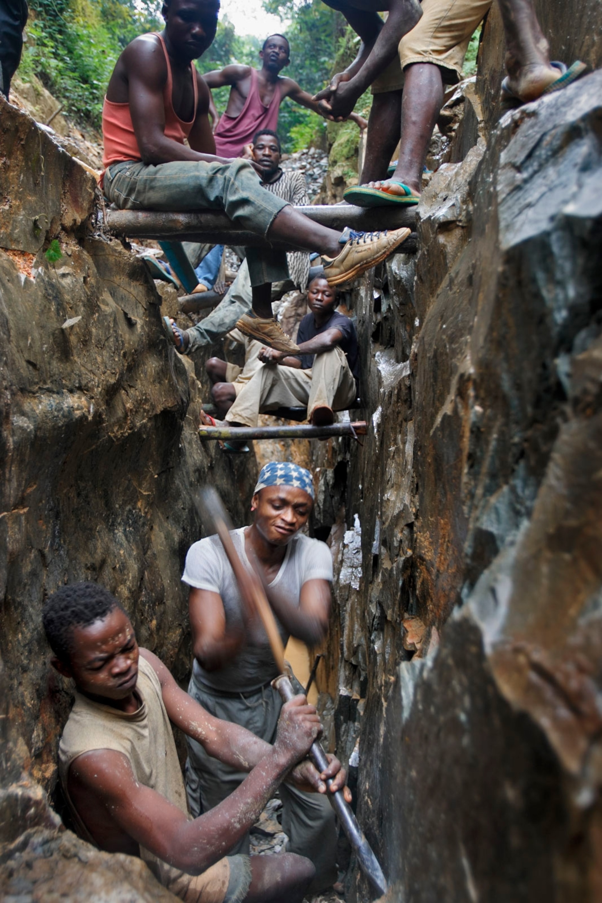 villagers in the Ituri region of the DRC scraping for gold in a shaft