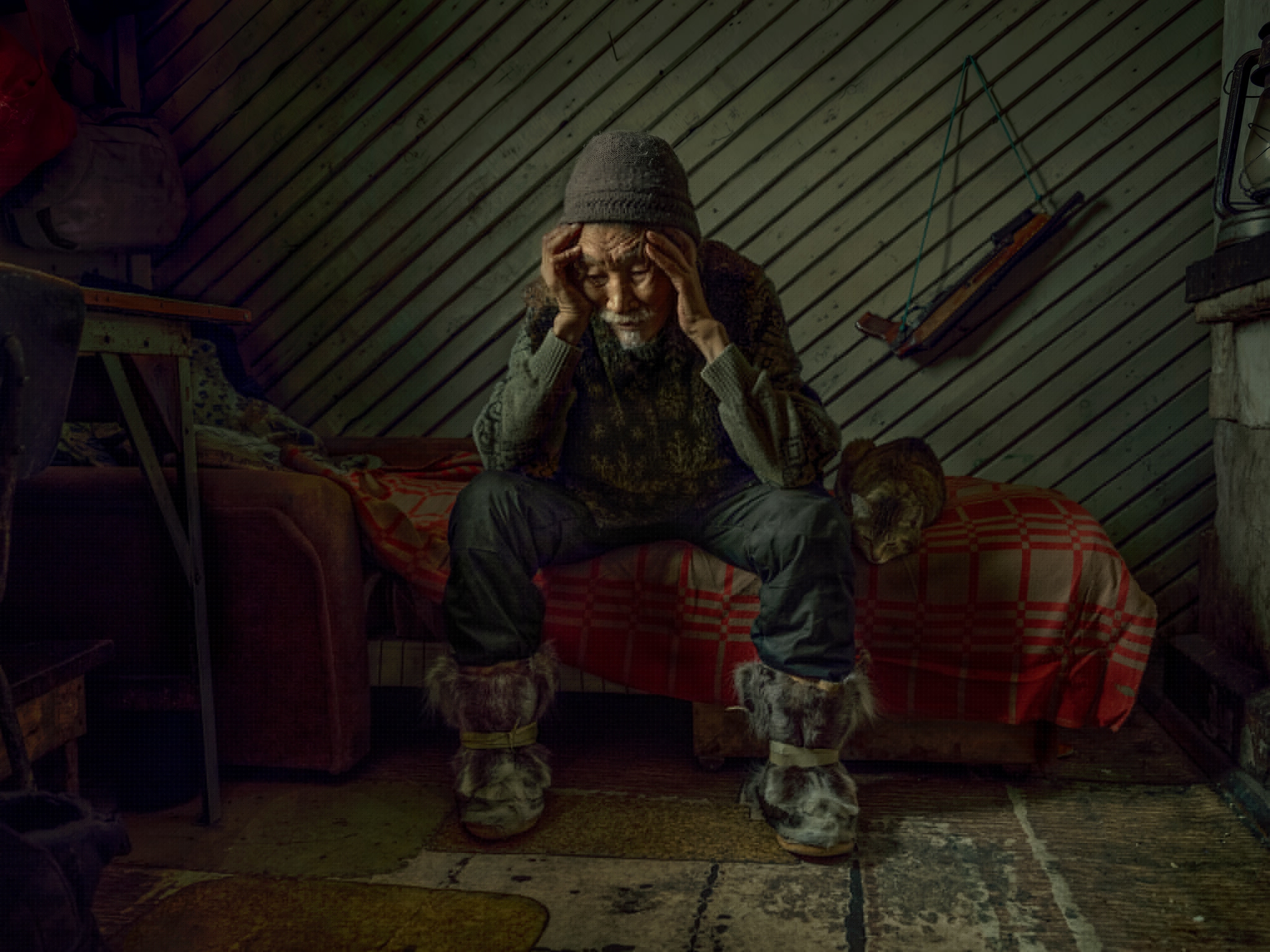 man sitting on bed.