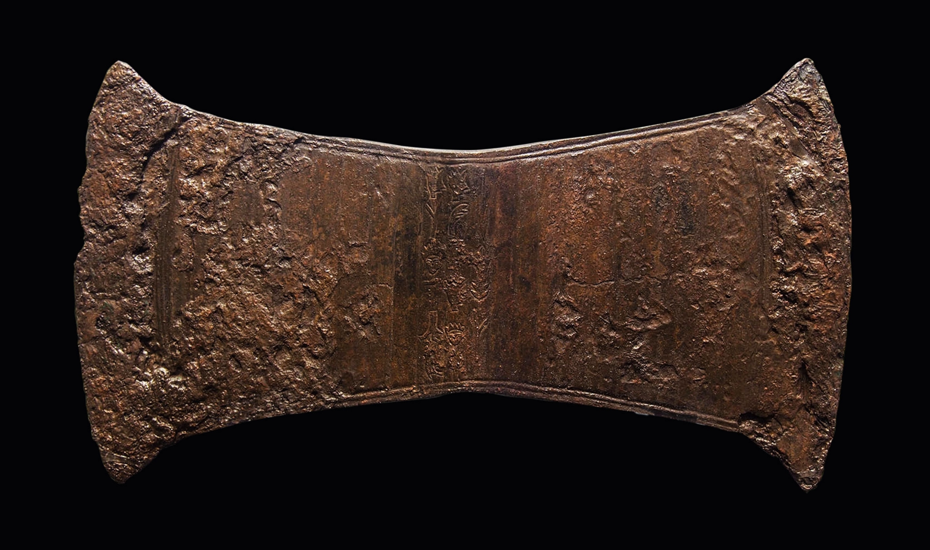 A worn metal ax head