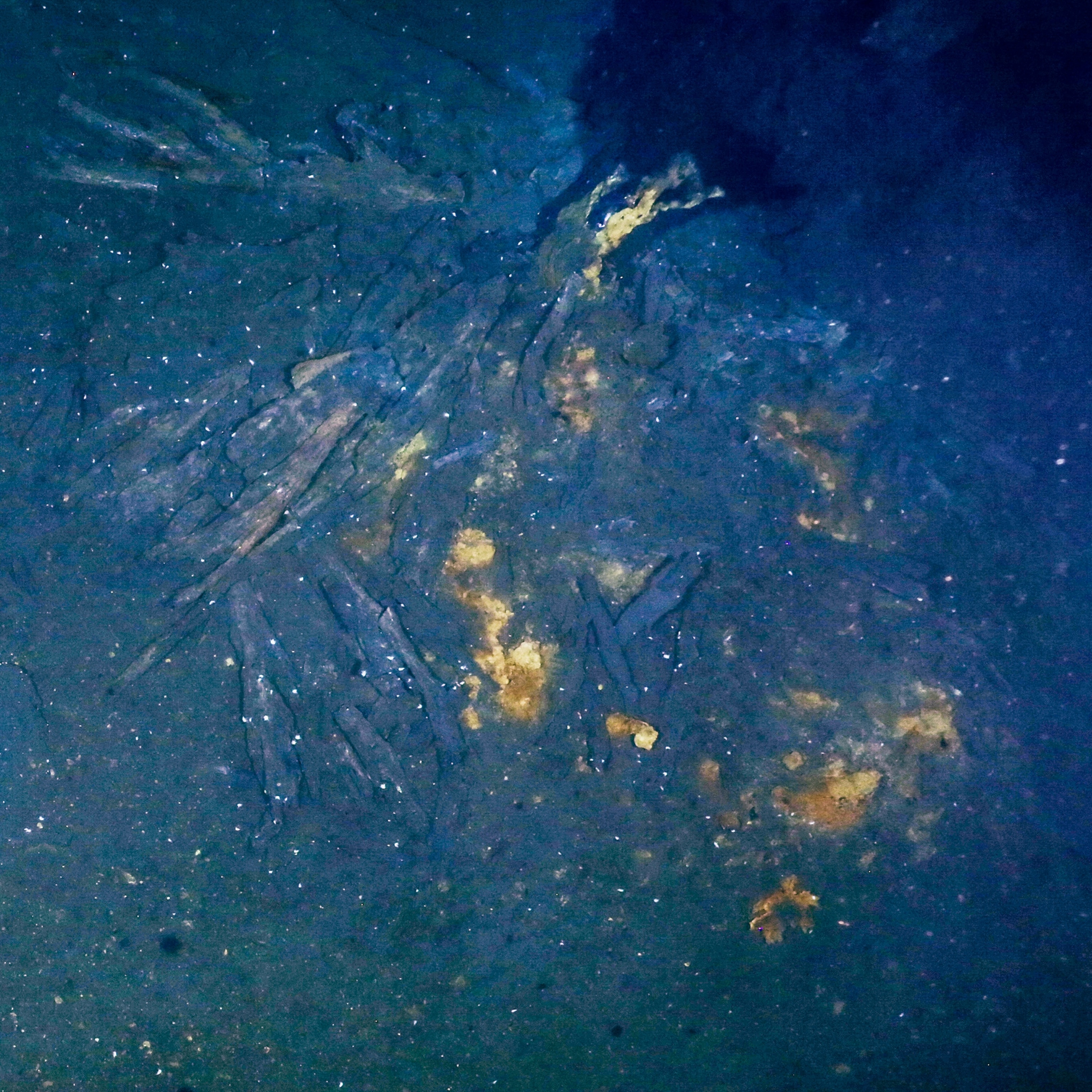 black smock from chimney in blue water