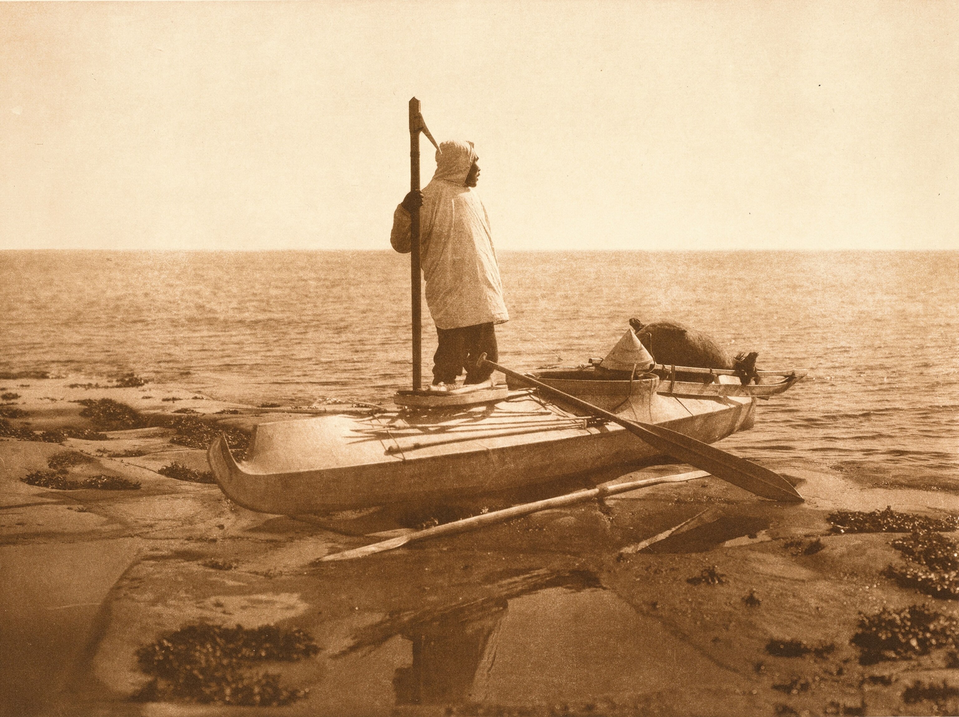 Photographed in the mid-20th century, a resident of Nunivak Island (which lies about 100 miles west of the present-day Nunalleq site) gazes out of the cold waters where he hunts seal and other aquatic mammals.