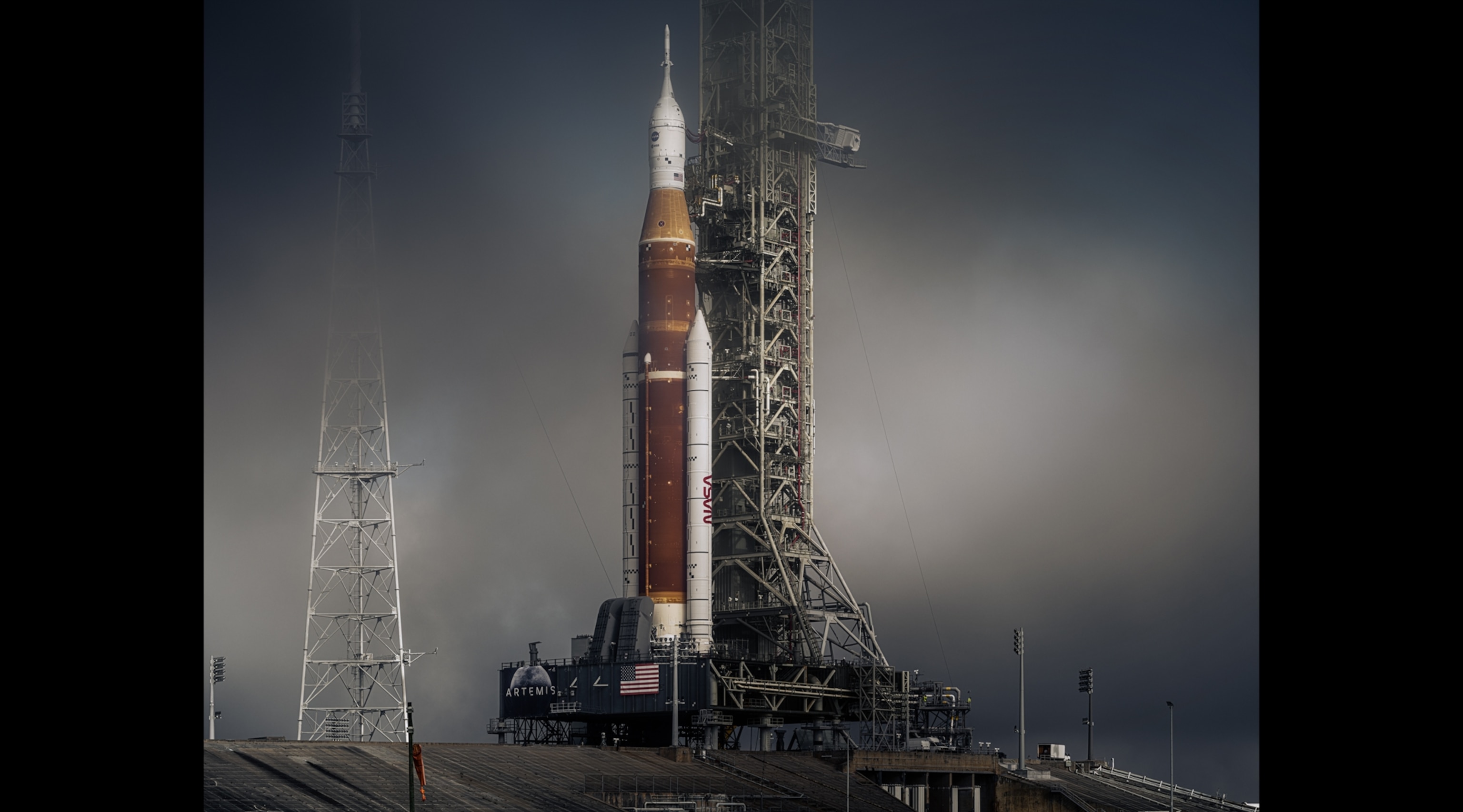 A rocket about to launch, surrounded by morning mist