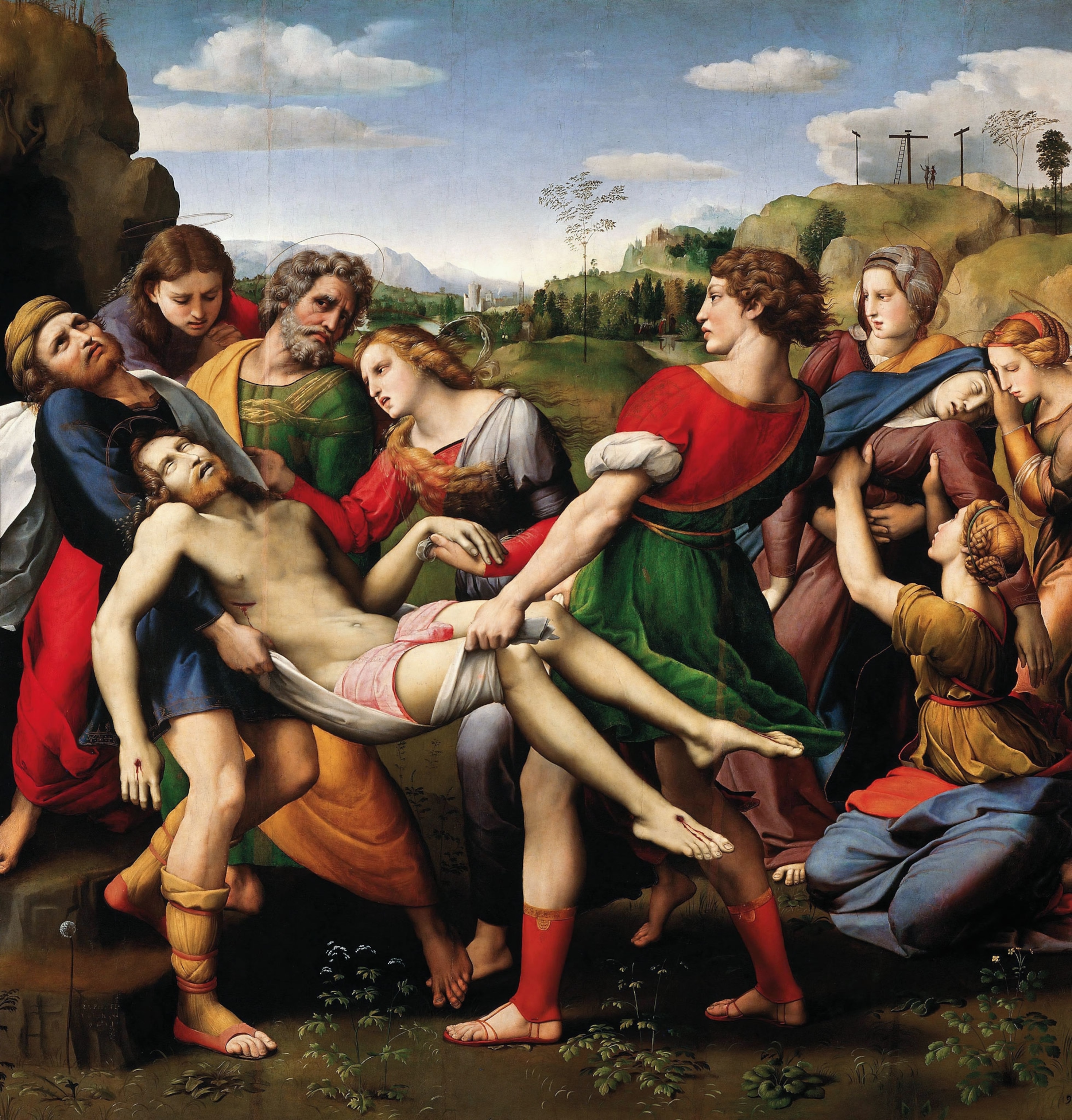 A crowd of people carry the body of Jesus Christ