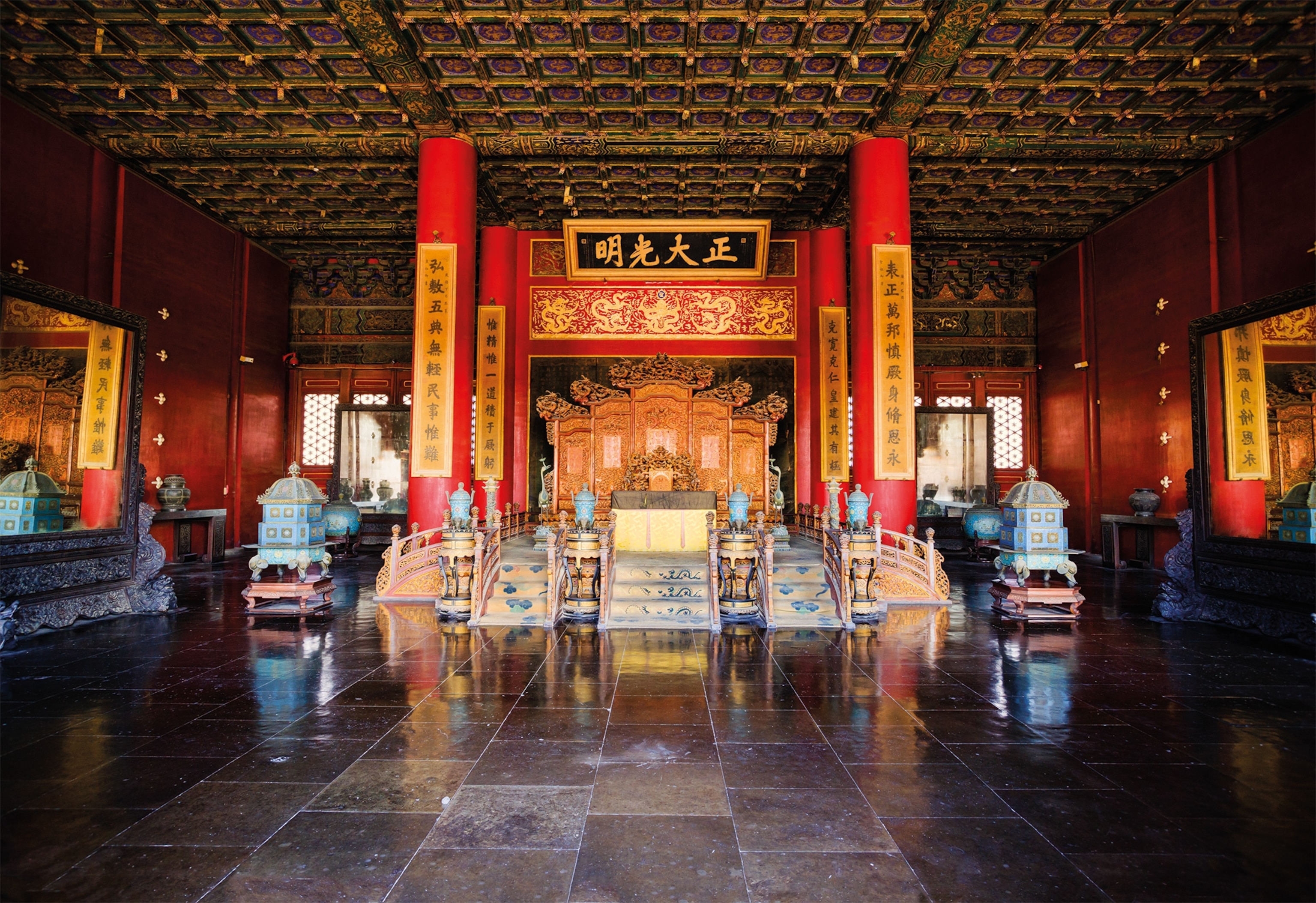 The Dragon Throne is about 500 years old, carved entirely from rosewood, and finished with yellow lacquer. Seven steps lead up to it. Behind it, a large carved wooden screen with five hinged panels protected the emperor from evil influences from the north.