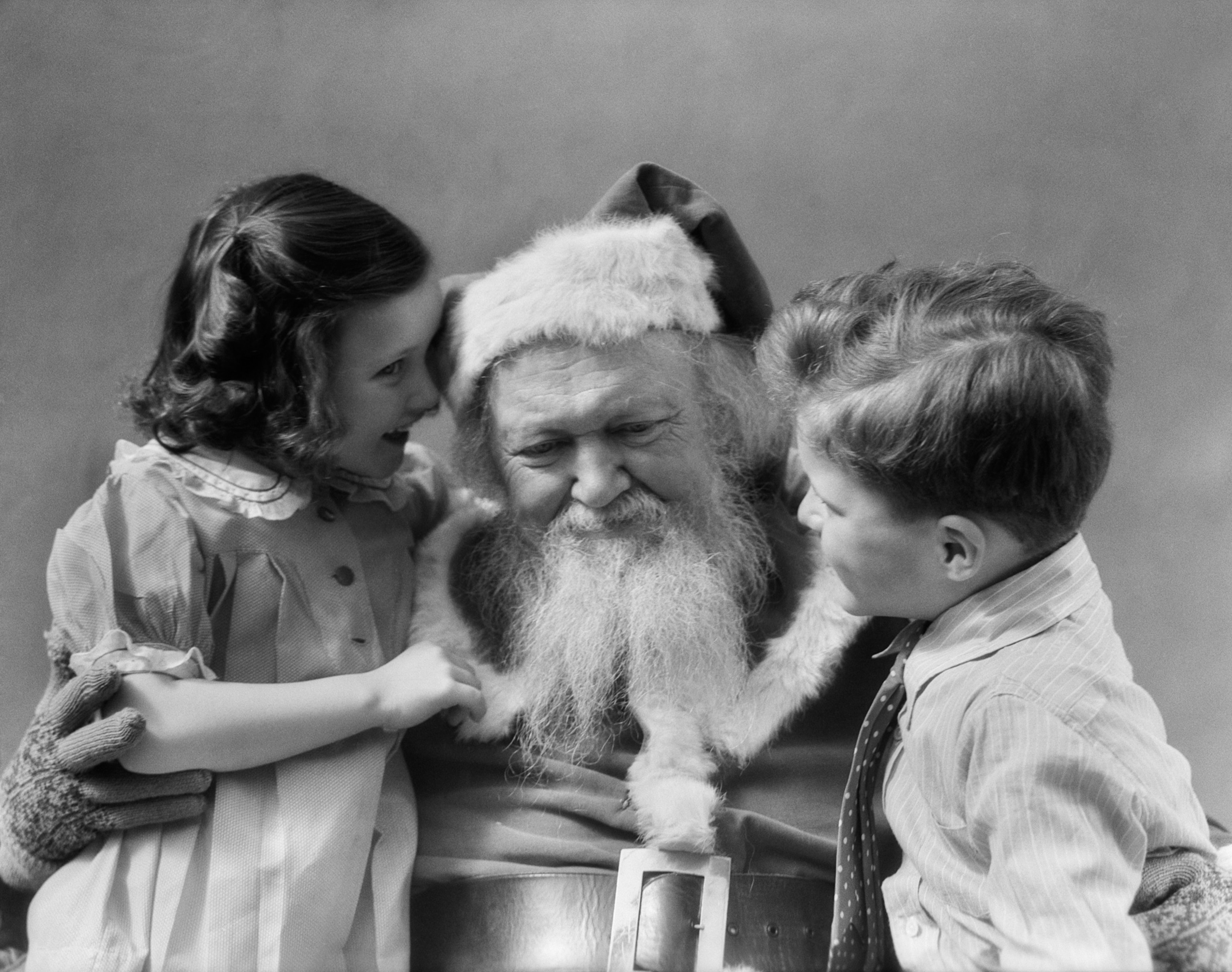 a little boy and little girl talking to Santa.