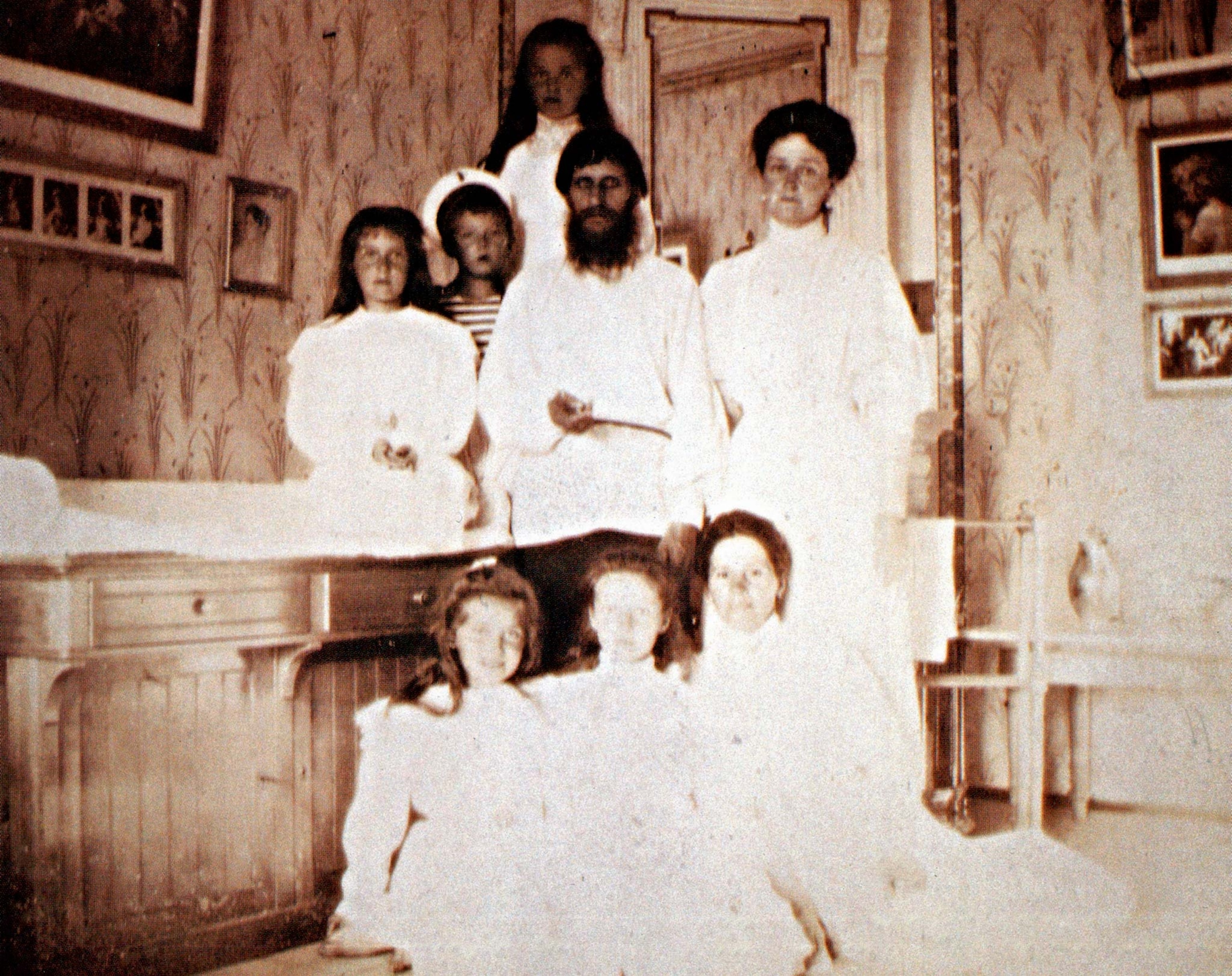 In a photograph taken around 1909, Rasputin poses with Tsarina Alexandra, her four daughters, her son, Alexei, and Alexei’s nanny, Maria Vishnyakova.