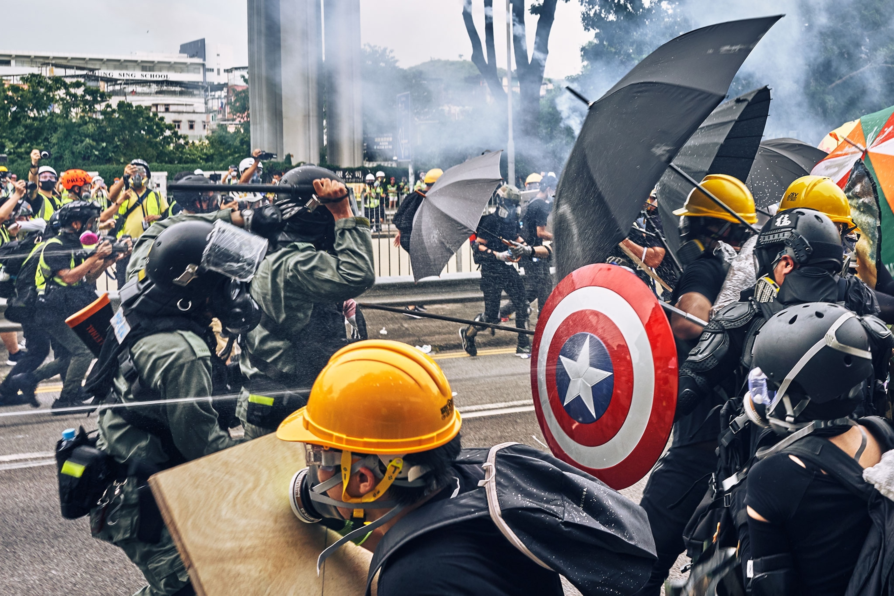protesters and police fighting at a protest in Hong Kong