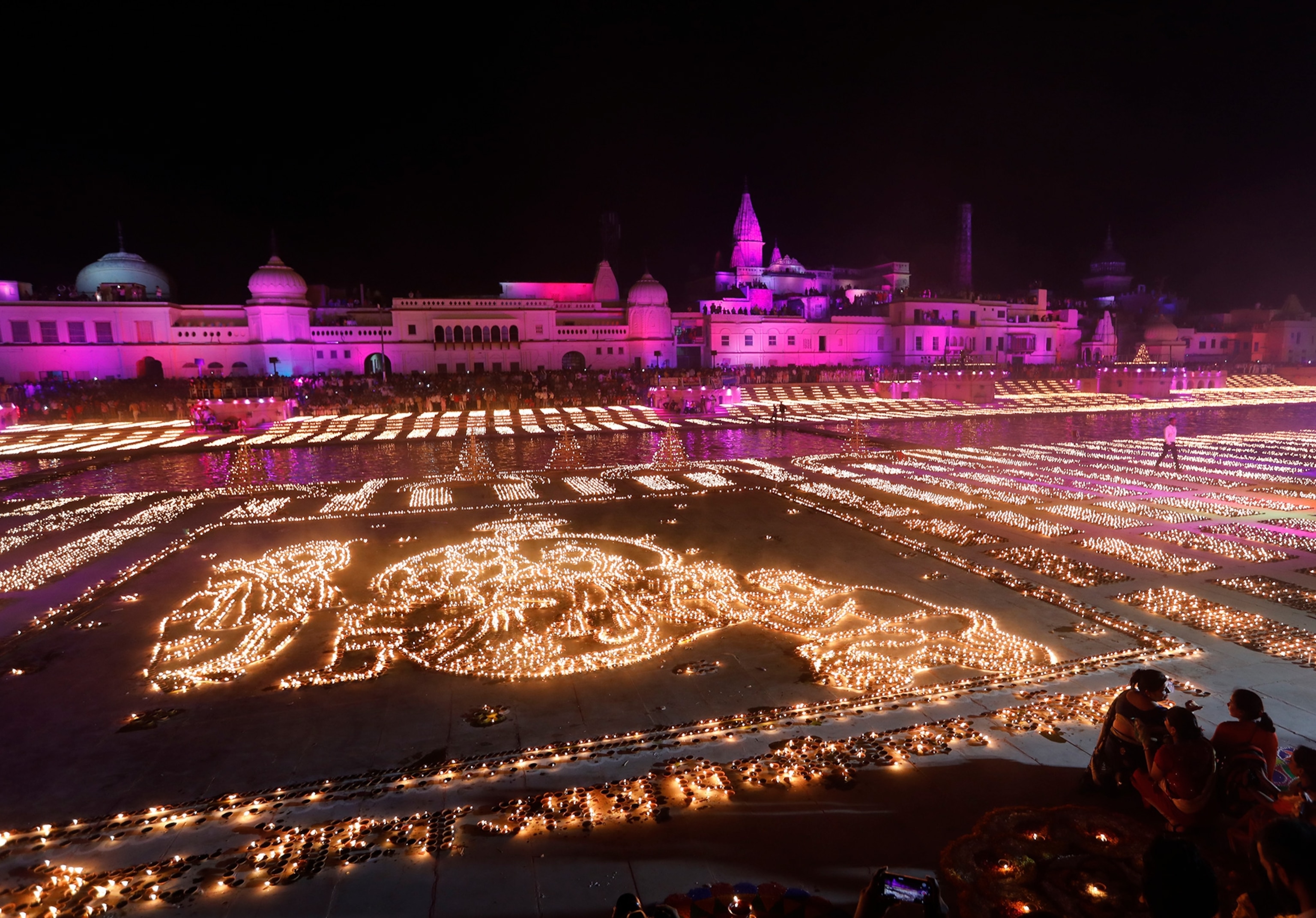 People light earthen lamps on the banks of the River Sarayu as part of Diwali celebrations in Ayodhya, India.