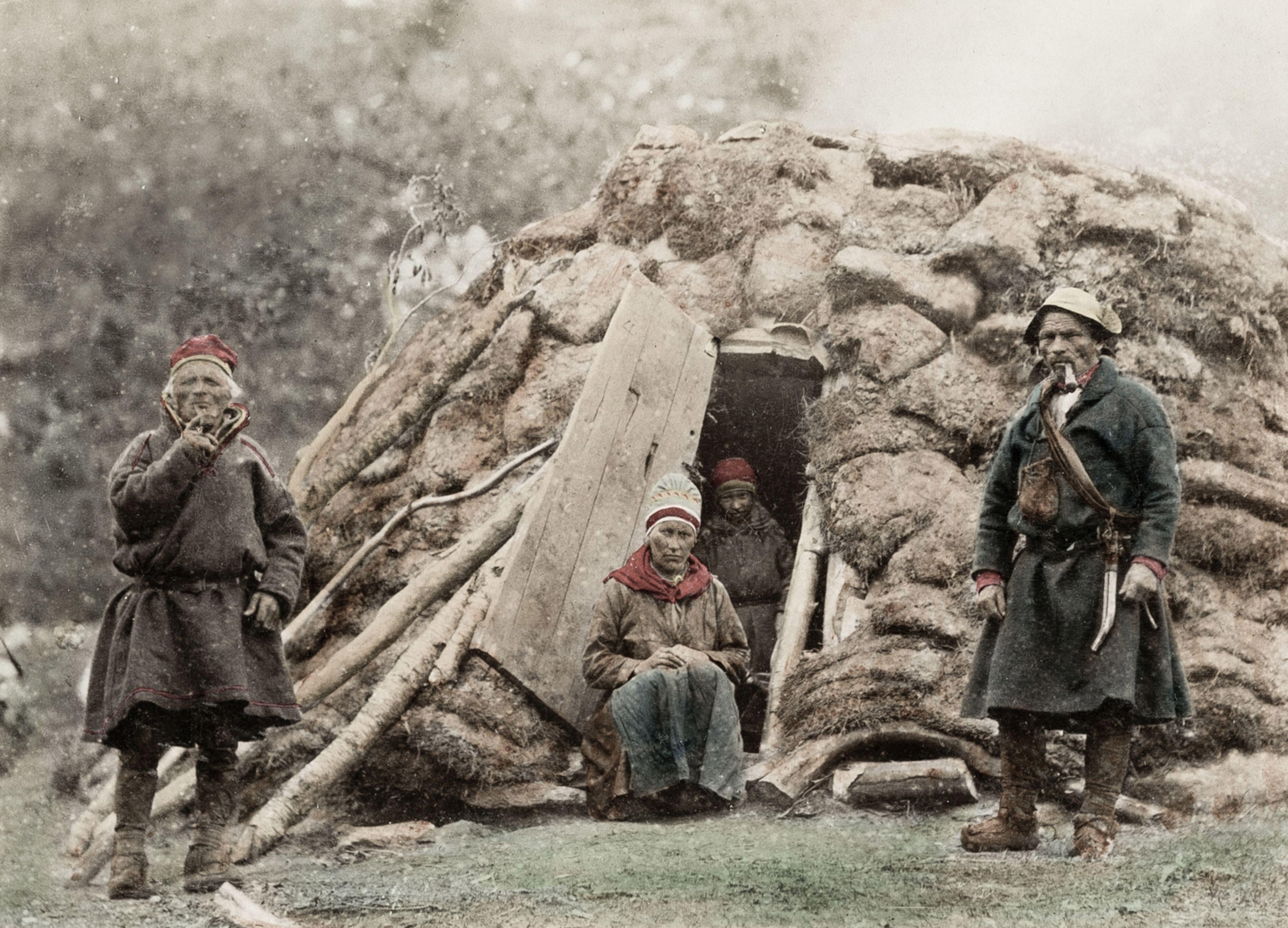 four people stand in a vintage Sami home