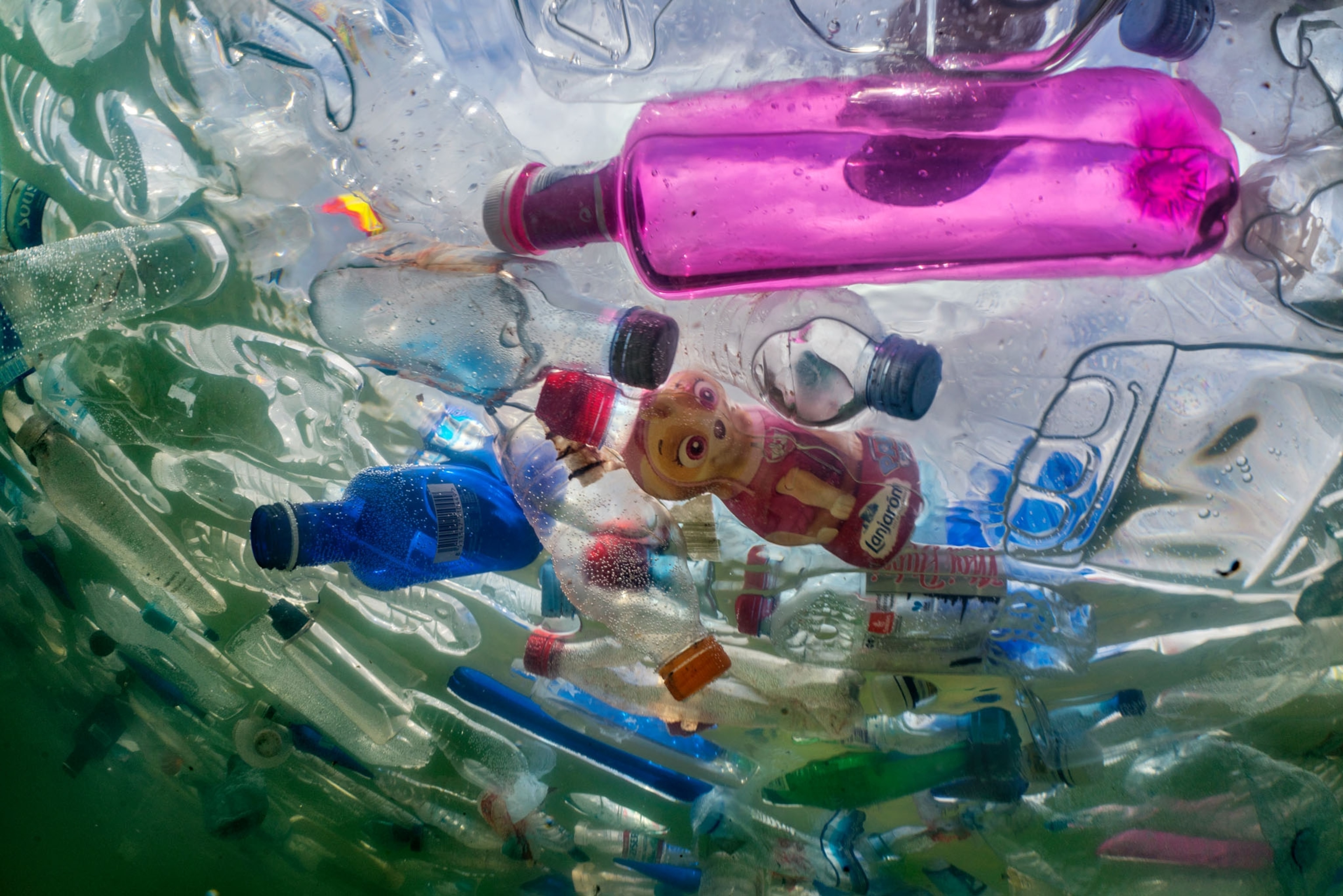an underwater scene filled with various colorful plastic bottles