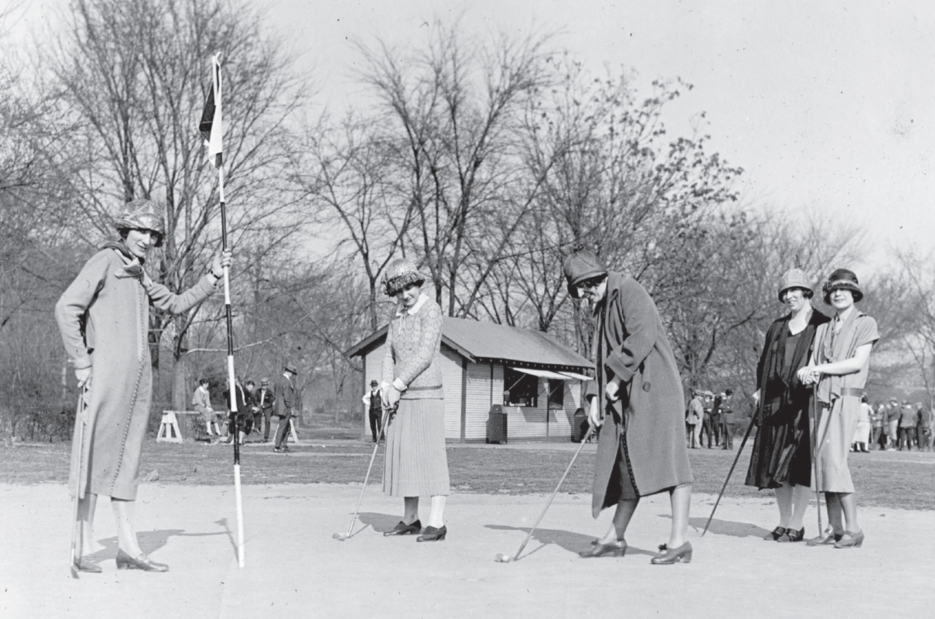 Dressed elegantly women playing golf